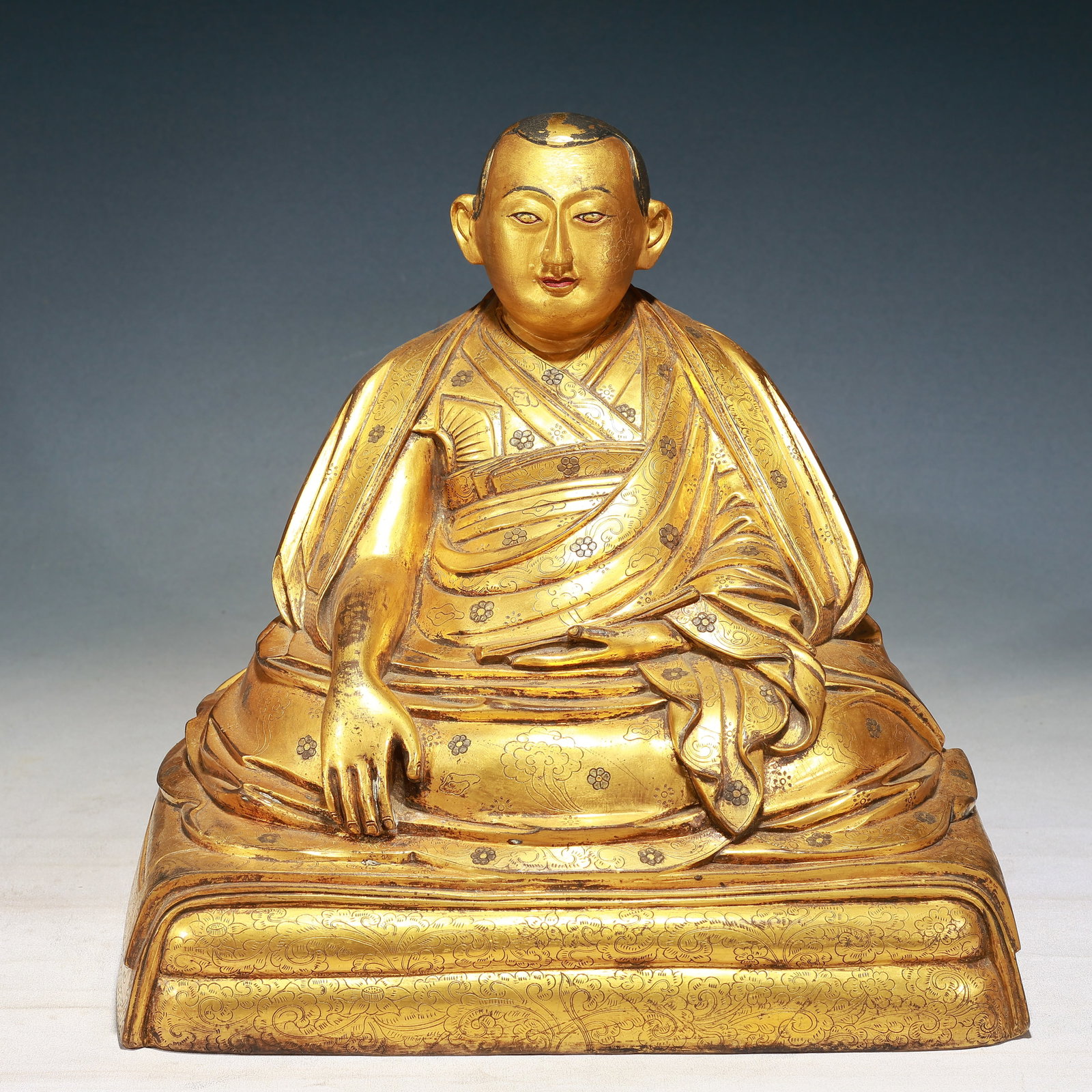 A Solemn Gilt Bronze Flower Pattern Statue of Guru,With Inscription: A Solemn Gilt Bronze Flower Pattern Statue of Guru,With Inscription,Qing Dynasty,China,Size:13.4inx10.6inx13in,Weight:13750g 铜鎏金花卉纹上师像,&#