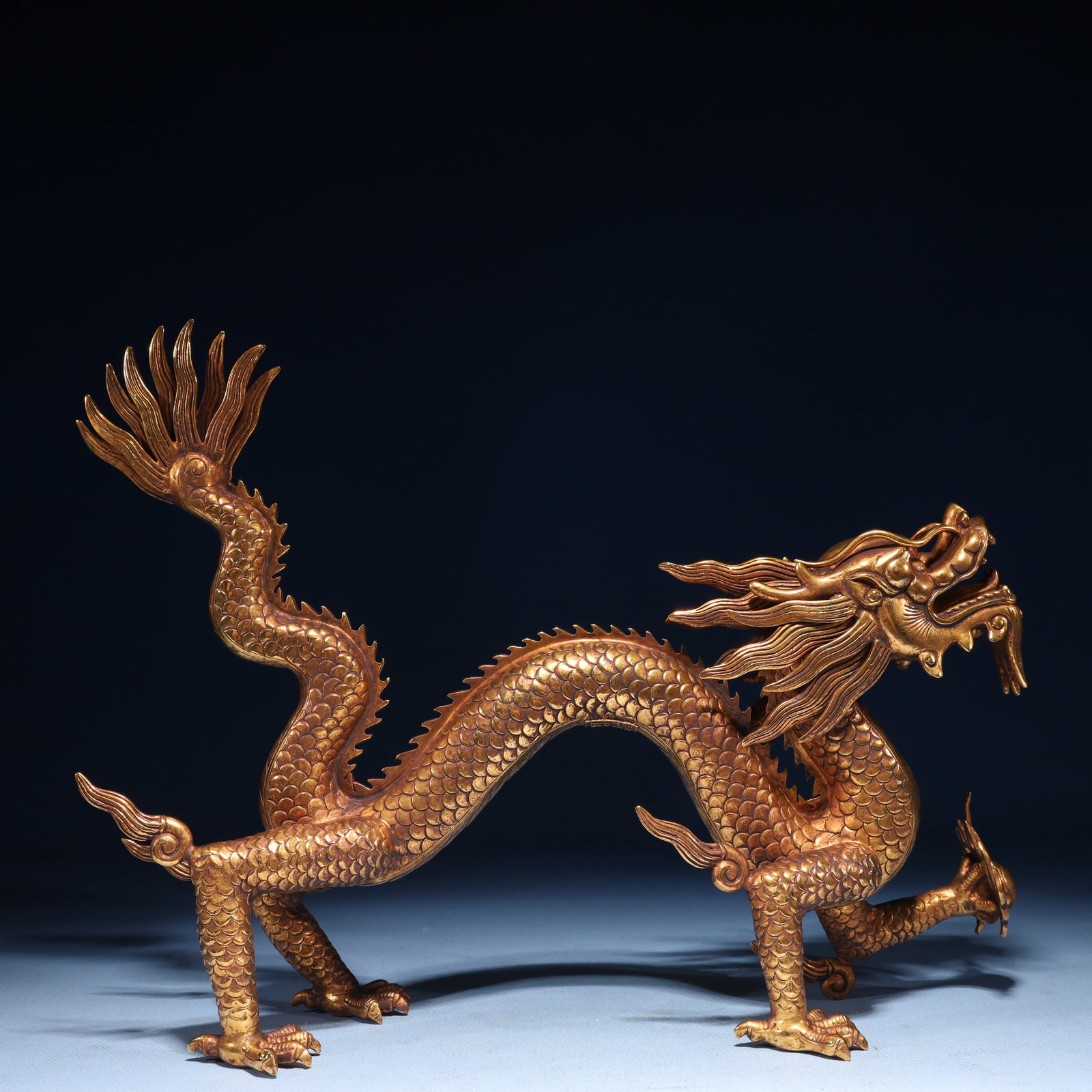An Exquisite Gilt Bronze Dragon Ornament: An Exquisite Gilt Bronze Dragon Ornament,Qing Dynasty,China,Qianlong Four-character Mark,Size:14.6inx3.7inx9.8in,Weight:3450g 铜鎏金龙摆件,中国清&