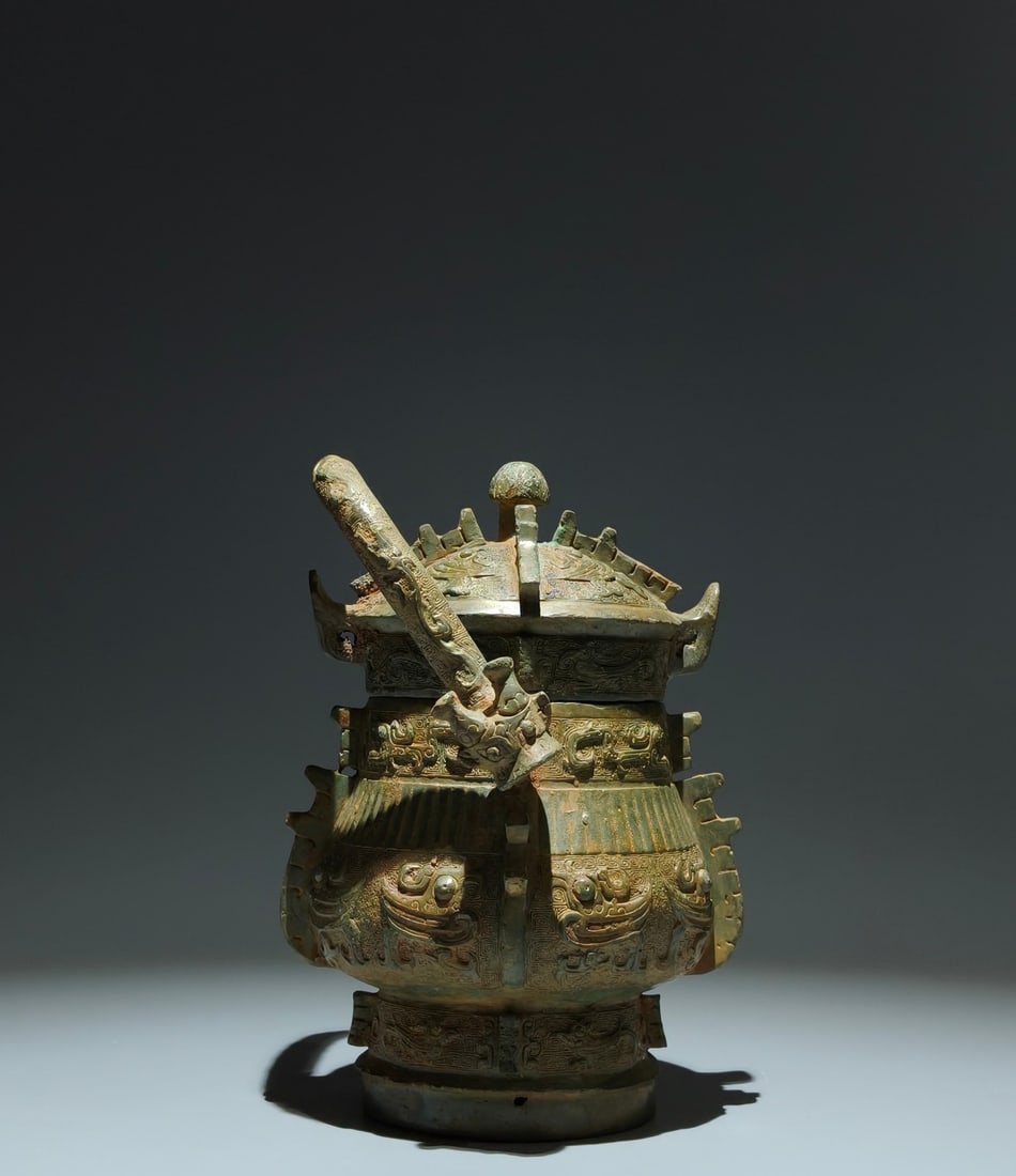 An Archaic Bronze Bird Pattern Loop-Handled Pot,With Inscription: An Archaic Bronze Bird Pattern Loop-Handled Pot,With Inscription,W.Zhou,China,Size:9.4inx6.3inx5.9in 青铜鸟纹提梁壶,带铭文,中国&