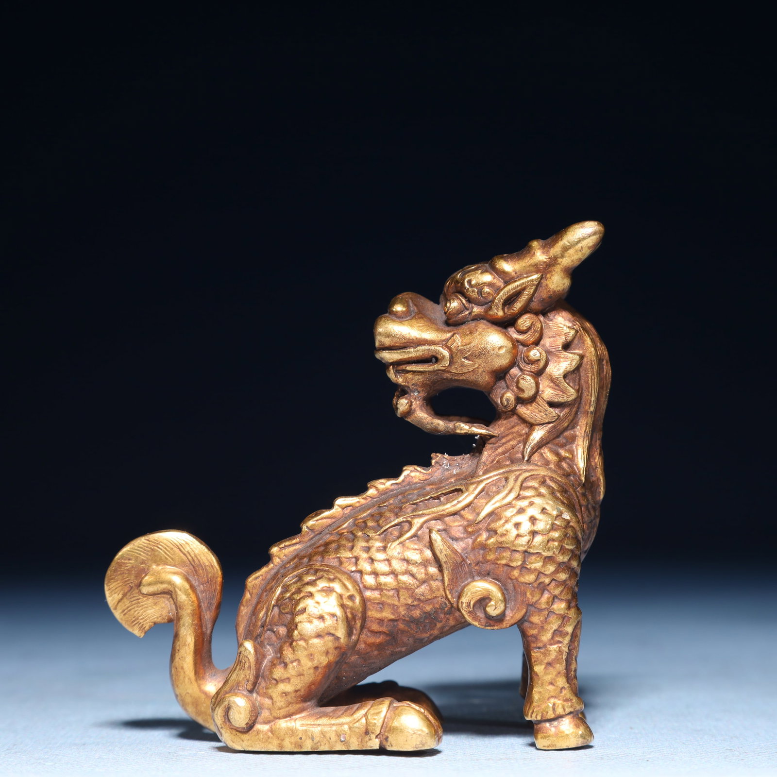 An Exquisite Gilt Bronze Kylin Ornament: An Exquisite Gilt Bronze Kylin Ornament,Qing Dynasty,China,Size:3.1inx1.4inx2.8in,Weight:300g 铜鎏金麒麟摆件,中国清代