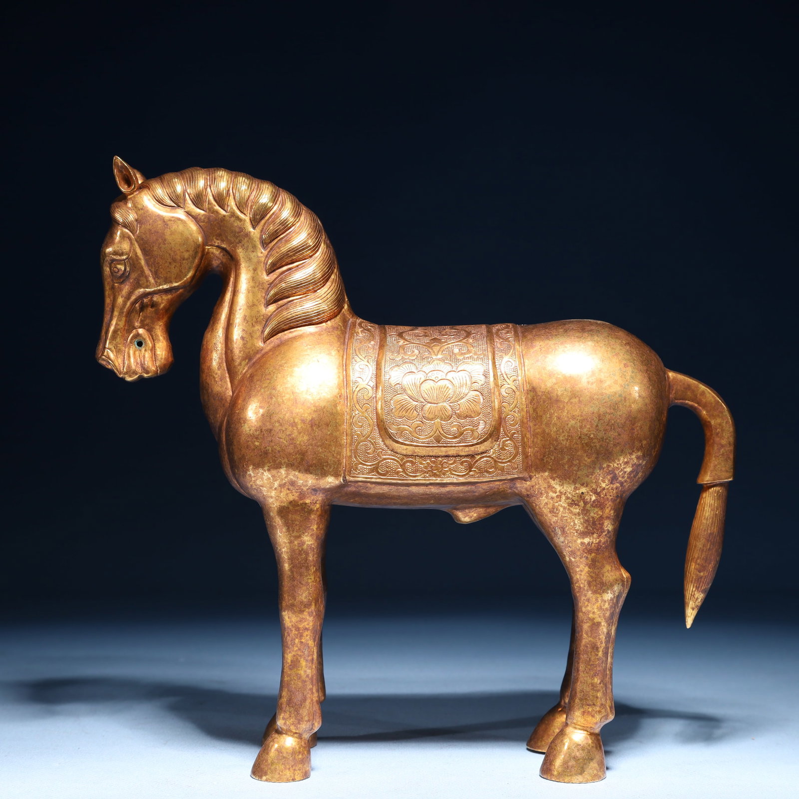 An Exquisite Gilt Bronze Lotus Pattern Horse Ornament: An Exquisite Gilt Bronze Lotus Pattern Horse Ornament,Qing Dynasty,China,Size:8.7inx2.8inx8.3in,Weight:1050g 铜鎏金缠枝莲纹骏马摆件,&#