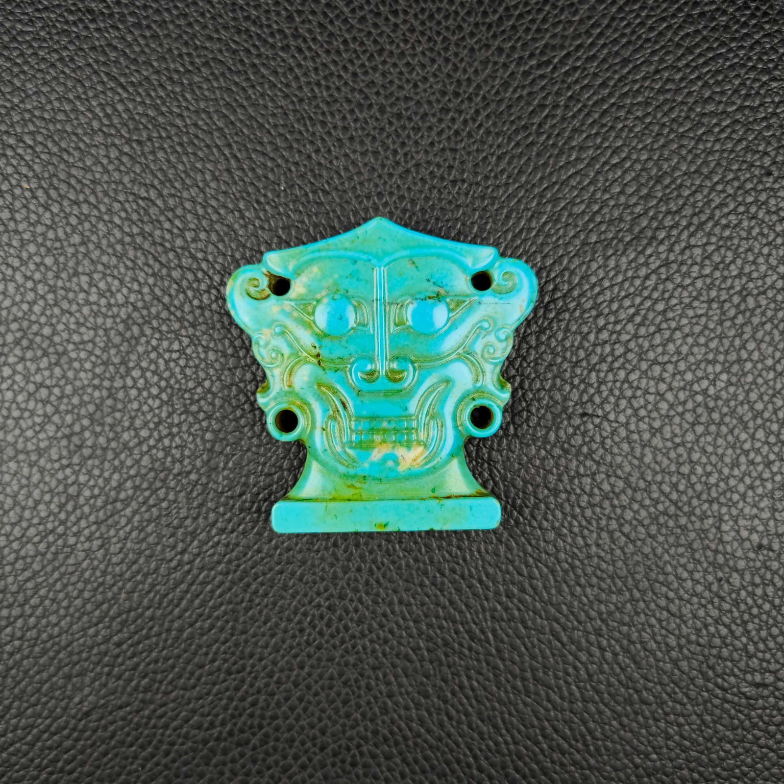 An Exquisite Turquoise Beast-Face Pattern Pendant: An Exquisite Turquoise Beast-Face Pattern Pendant the Warring States period in China Size:1.8inx1.8in Weight:31g绿松石兽面挂件