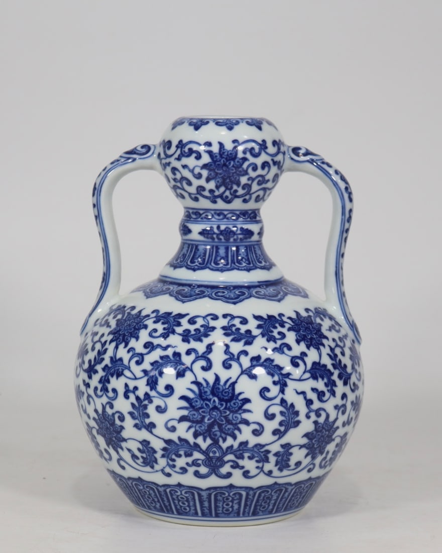 An Exquisite Blue and White Lotus Pattern Double-Ears Vase: An Exquisite Blue and White Lotus Pattern Double-Ears Vase Qing Dynasty, China Qianlong Six-character Mark Size:9.3inx6.3in青花缠枝花卉如意瓶 