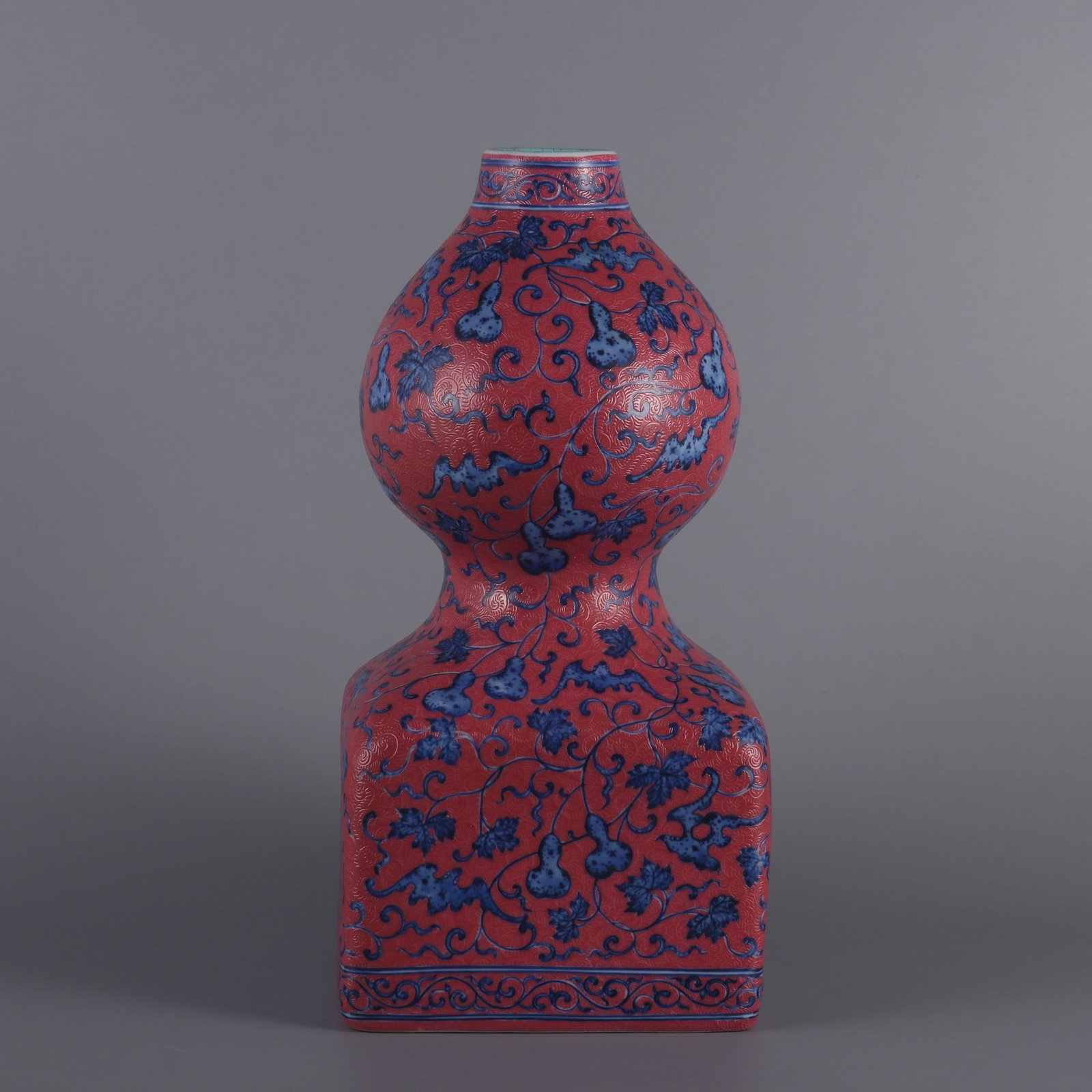An Exquisite Blue and White Ruby Red-Glazed Lotus Pattern Gourd-Shaped Vase: An Exquisite Blue and White Ruby Red-Glazed Lotus Pattern Gourd-Shaped Vase Qing Dynasty, China Qianlong Six-character Mark Size:11.6inx5.5in胭脂红地扒花青