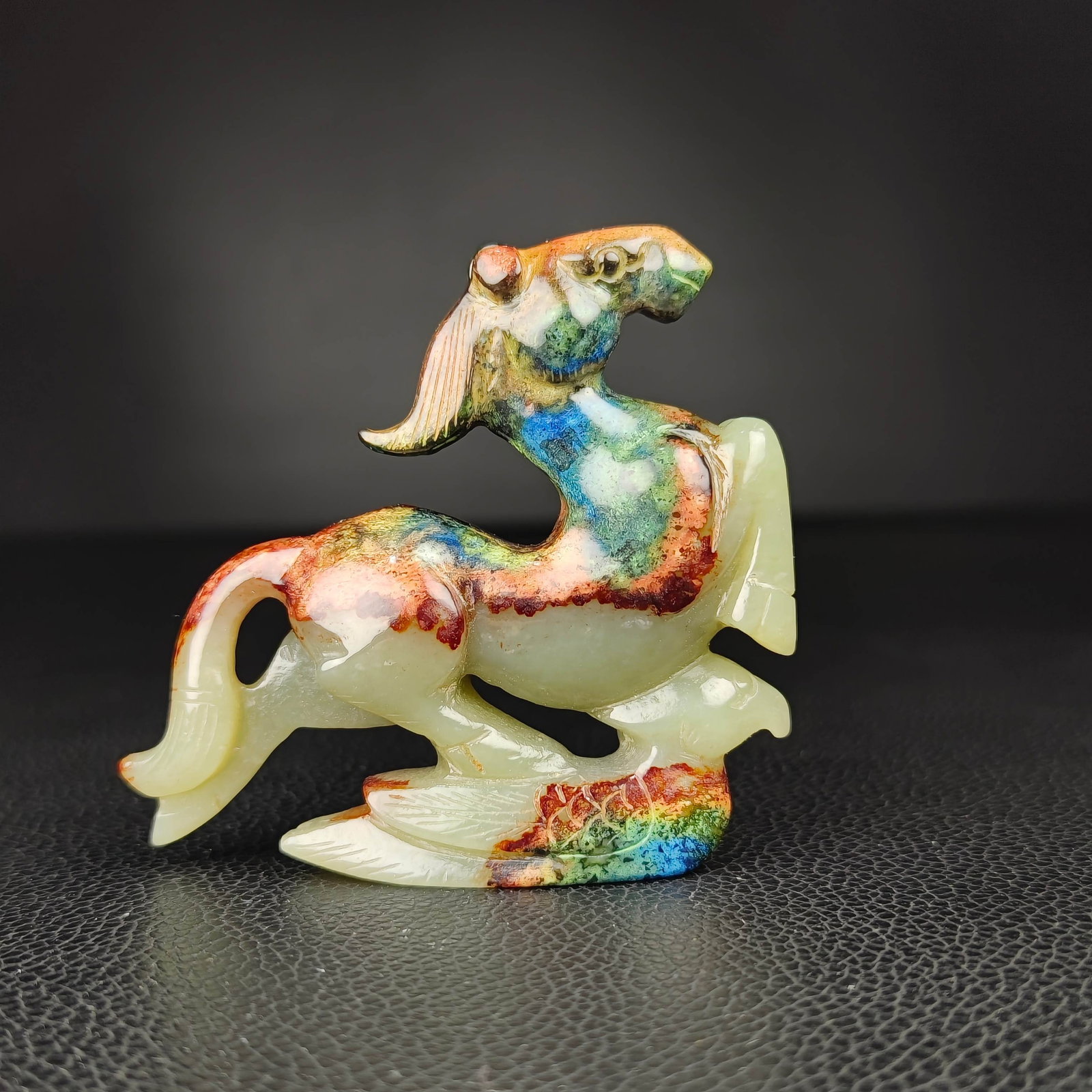An Exquisite White Jade Horse Ornament: An Exquisite White Jade Horse Ornament Han Dynasty, China Size:2.6inx2.8in Weight:76g白玉马踏飞燕 中国汉代 Size:6.5cmx7cm Weight:76g