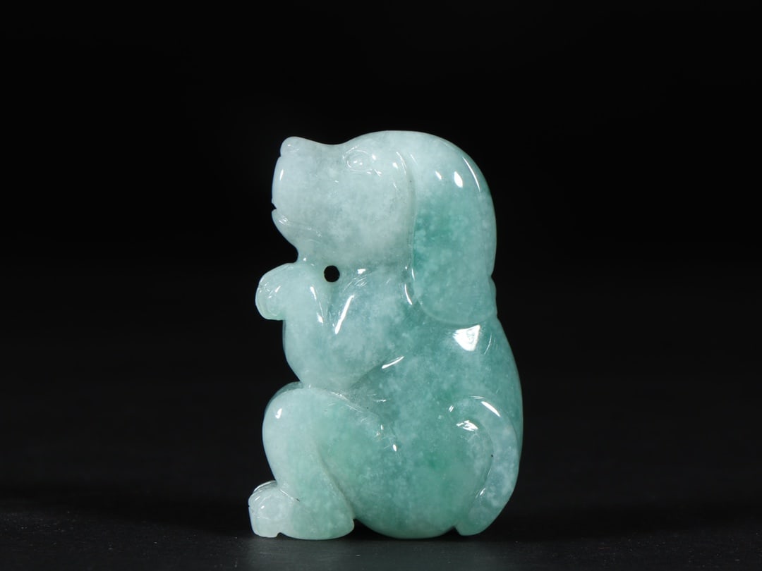 An Exquisite Jadeite Dog Ornament: An Exquisite Jadeite Dog Ornament Qing Dynasty, China Size:1.4inx0.6inx2in Weight:57g翡翠旺财 中国清代 Size:3.5cmx1.5cmx5.2cm Weight:57g