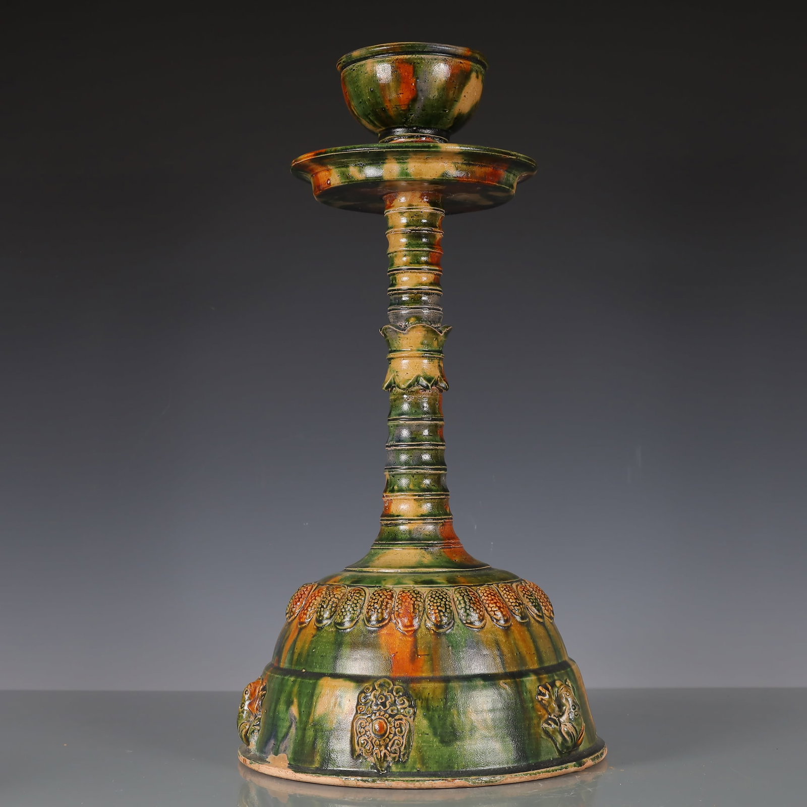 A Exquisite Trio-colored glazed pottery of the Tang Dynasty Flower Pattern Candlestick: A Exquisite Trio-colored glazed pottery of the Tang Dynasty Flower Pattern Candlestick Tang Dynasty, China Size:9.8inx9.8inx18.9in