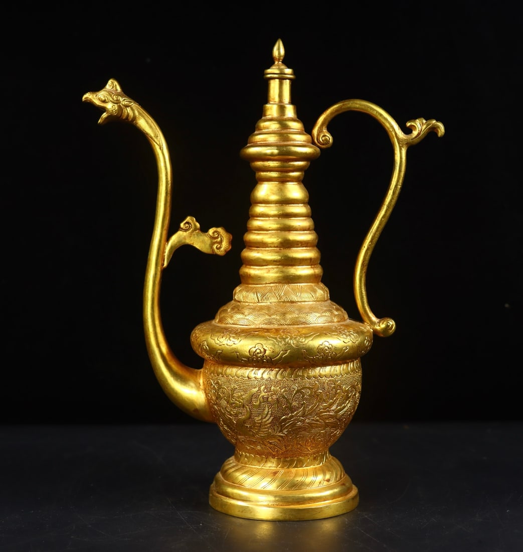 An Exquisite Gilt Bronze Phoenix Pattern Lotus Pattern Ewer: An Exquisite Gilt Bronze Phoenix Pattern Lotus Pattern Ewer Tang Dynasty, China Zhenguan Four-character Mark Size: 9.8inx7.3inx3.3in Weight:823g铜鎏金凤口壶