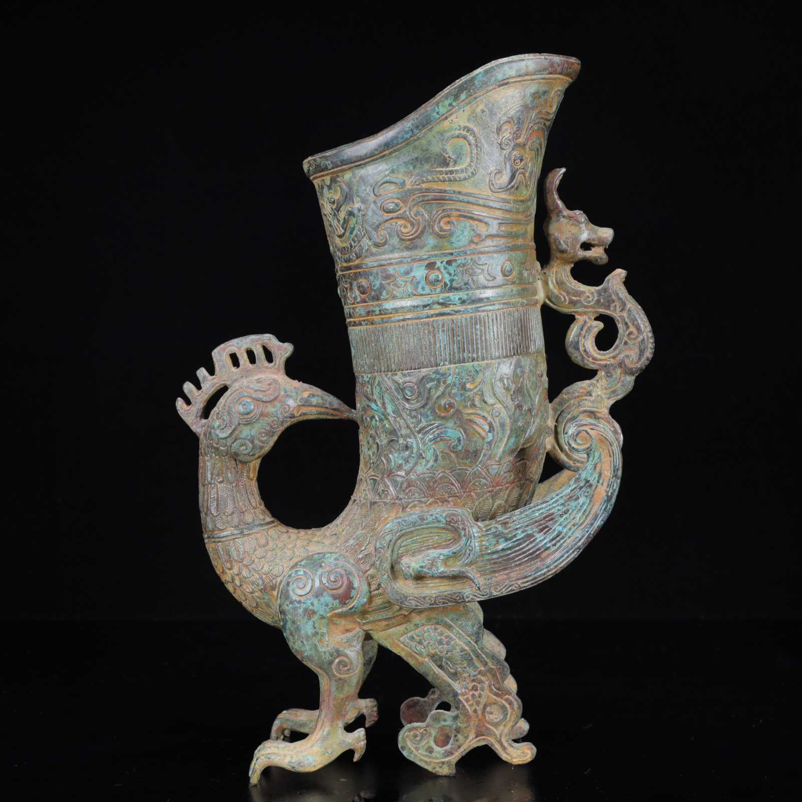 An Archaic Bronze Phoenix Pattern Cup: An Archaic Bronze Phoenix Pattern Cup,the Warring States Period in China,Size:8.7inx3.1inx11.8in,Weight:1950g 青铜凤纹凤杯,中国战国时&