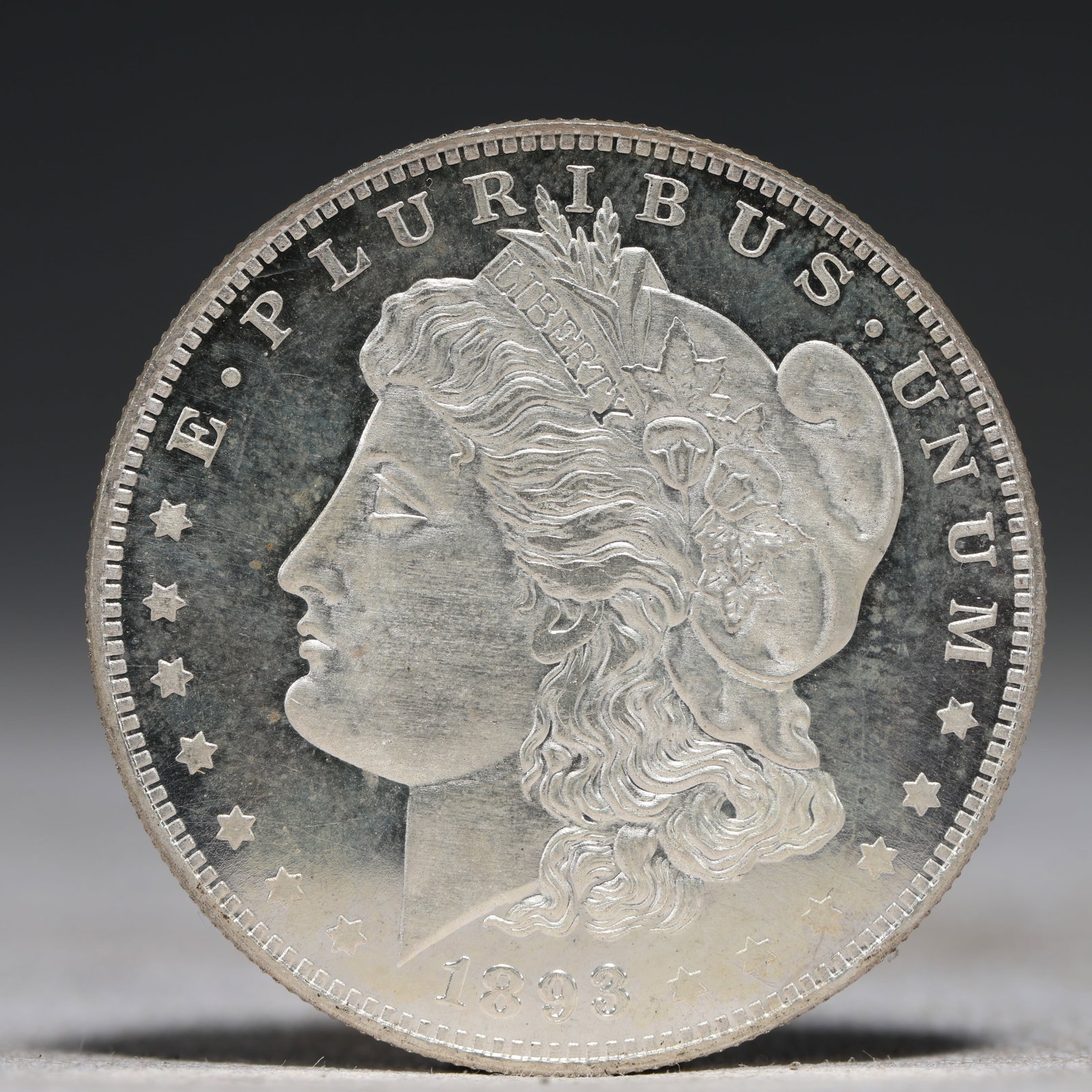 USA Morgan Dollar 1893 Coin: Obv: profile bust with date below and E PLURIBUS UNUM legend and stars around. Rev: eagle with In God we trust above within wreath with UNITED STATES OF AMERICA ONE DOLLAR legend. IN GOD WE TRUST / LI
