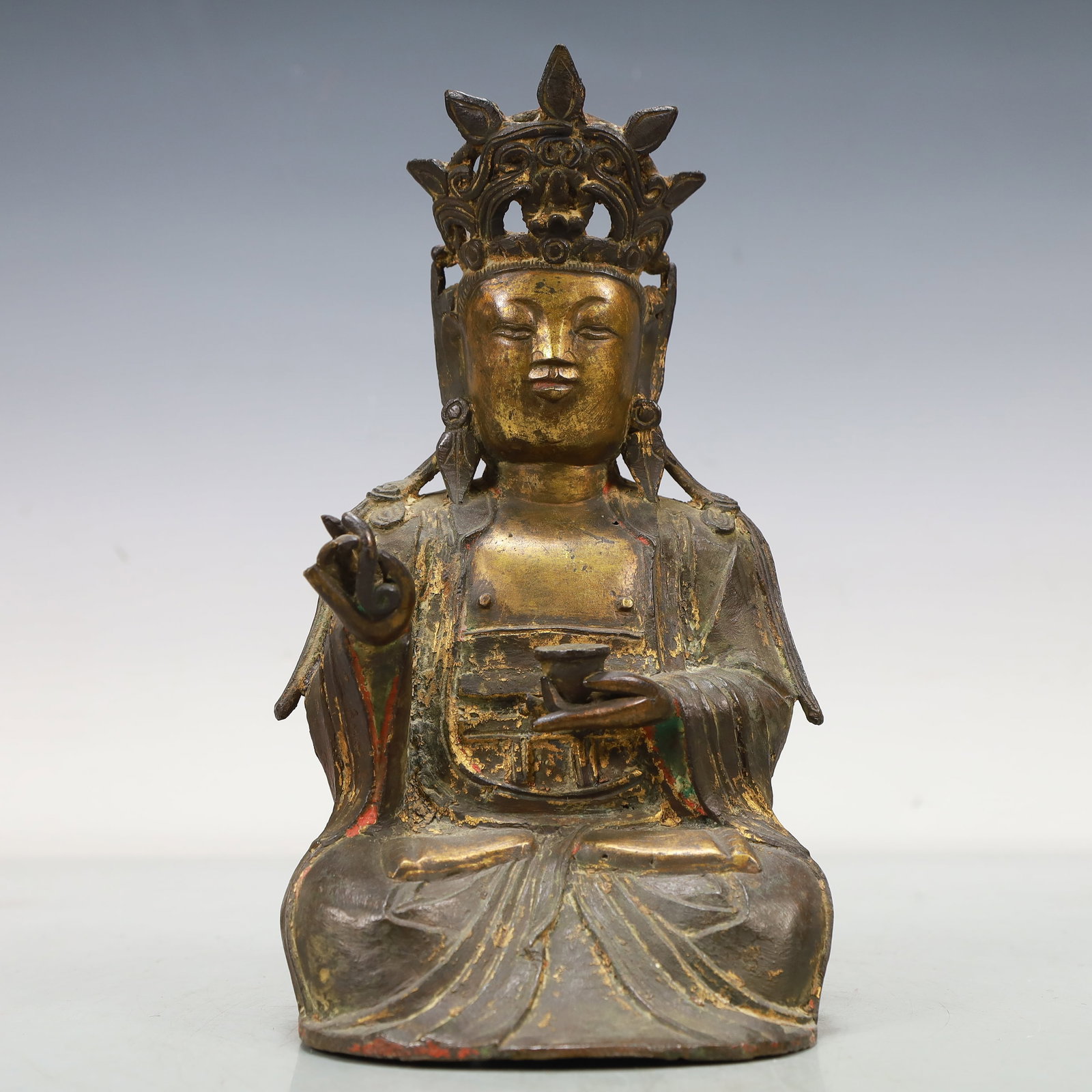 An Excellent Gilt-Bronze Figure Of Guanyin: An Excellent Gilt-Bronze Figure Of Guanyin. Seated,body rendered clad in long,flowing robes,the voluminous drapery elegantly cascading in folds. Chinese Ming Dynasty. Size:4.3inx4.1inx8.5in. Weight:11