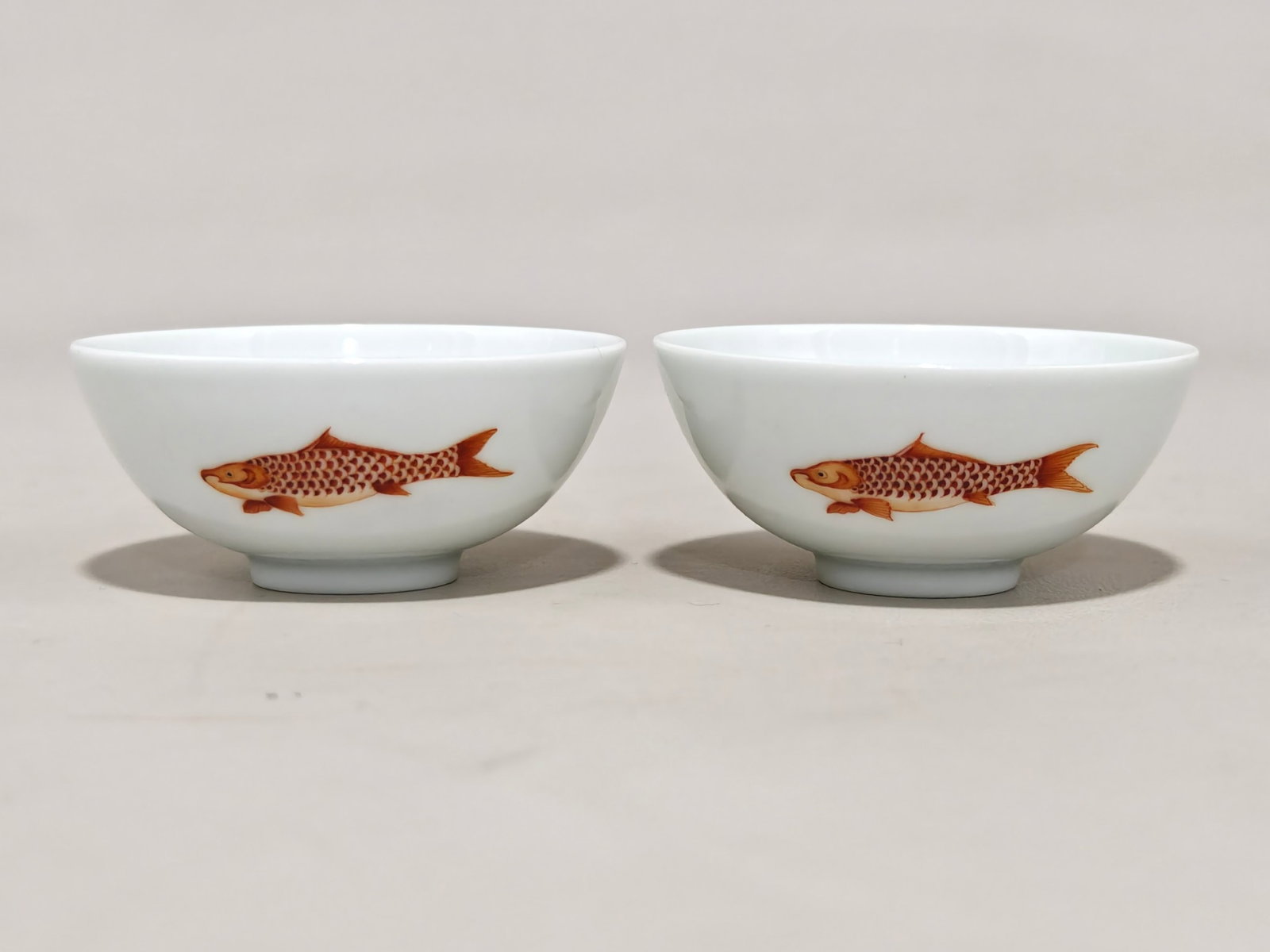 A Pair of Exquisite Iron-Red Bats and Fish Pattern Cups: A Pair of Exquisite Iron-Red Bats and Fish Pattern Cups,Qing Dynasty,China,Yongzheng Six-character Mark,Size:1.1inx2.6in