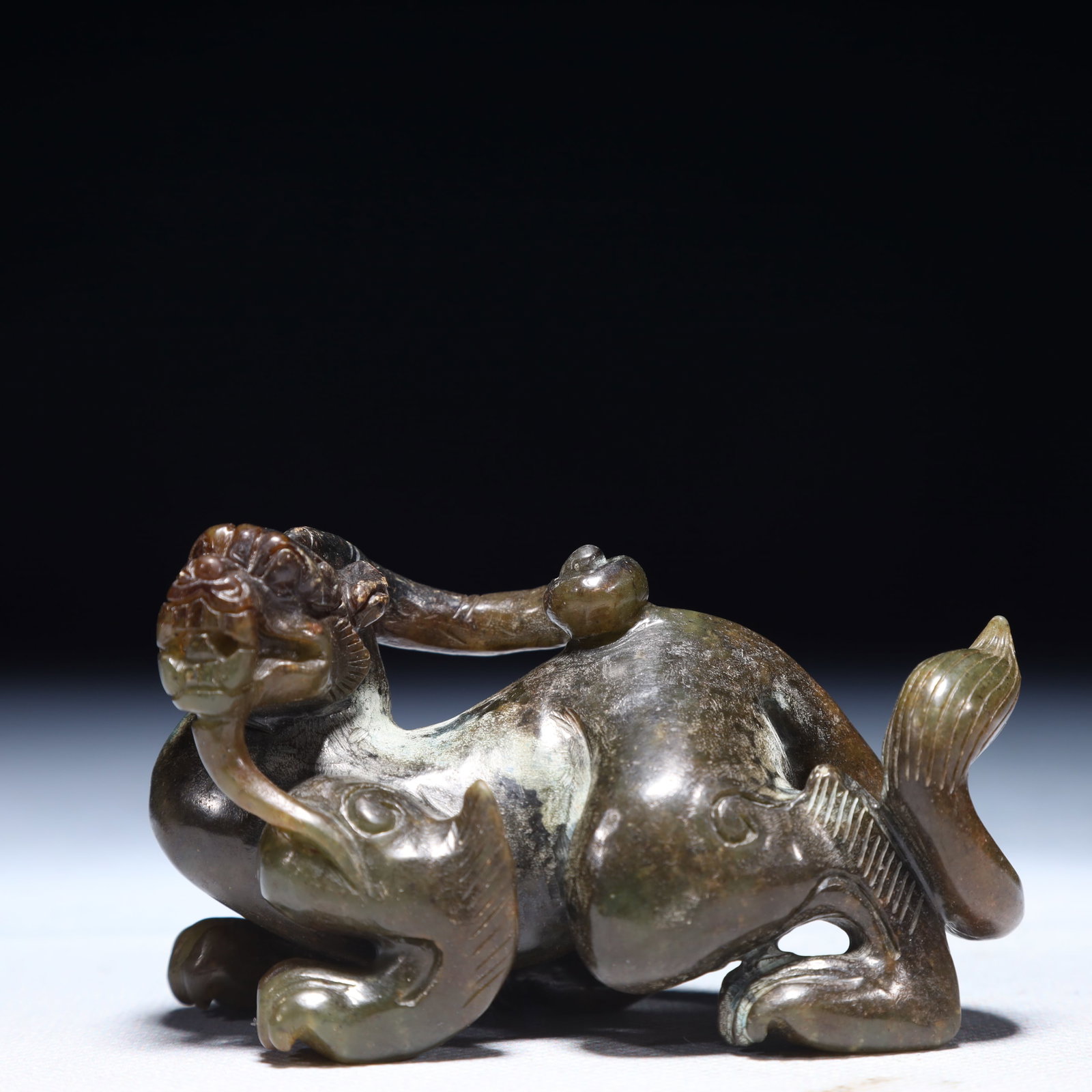 An Exquisite Green Jade Auspicious Beast Ornament: An Exquisite Green Jade Auspicious Beast Ornament,Qing Dynasty,China,Size:3.3inx1.4inx2in,Weight:150g 青玉瑞兽摆件,中国清代