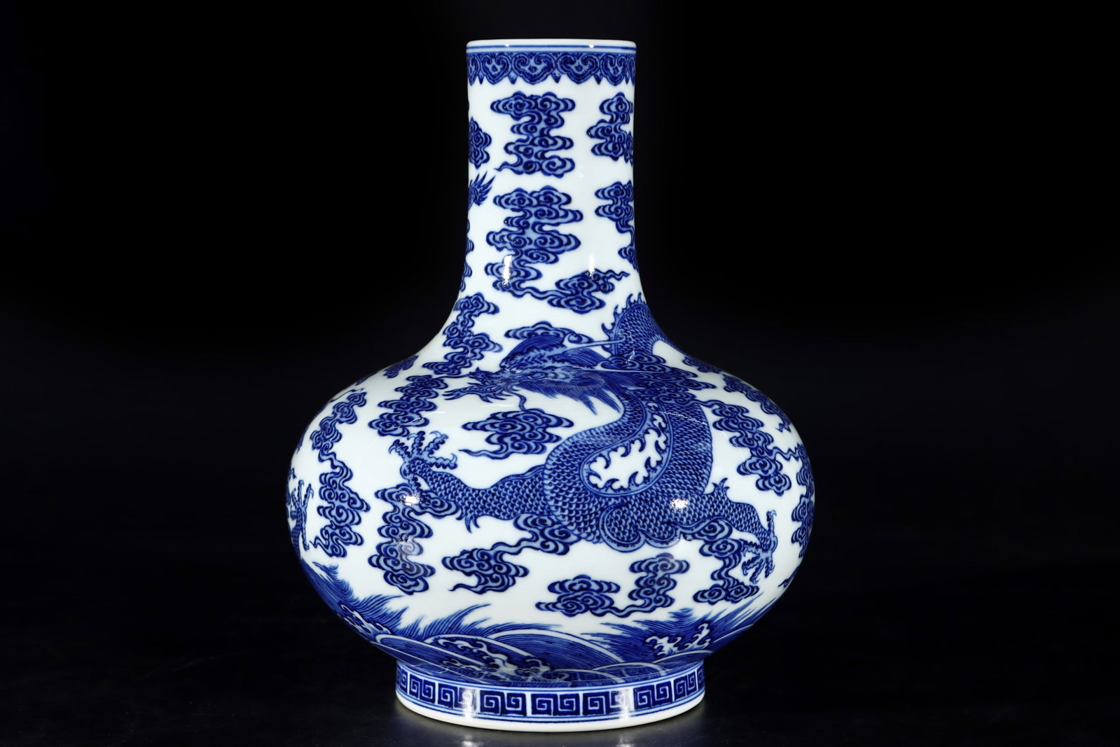 An Exquisite Blue and White Auspicious Cloud and Dragon Pattern Vase: An Exquisite Blue and White Auspicious Cloud and Dragon Pattern Vase,Qing Dynasty,China,Qianlong Six-character Mark,Size:11.3inx9.1in