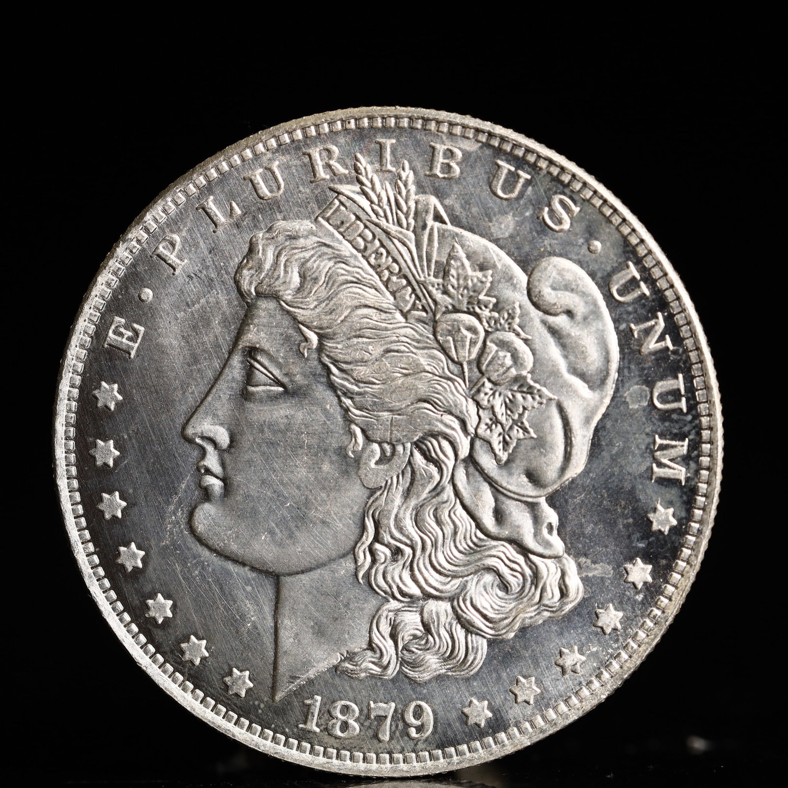 USA Morgan Dollar 1879 Coin: Obv: profile bust with date below and E PLURIBUS UNUM legend and stars around. Rev: eagle with In God we trust above within wreath with UNITED STATES OF AMERICA ONE DOLLAR legend. IN GOD WE TRUST / LI