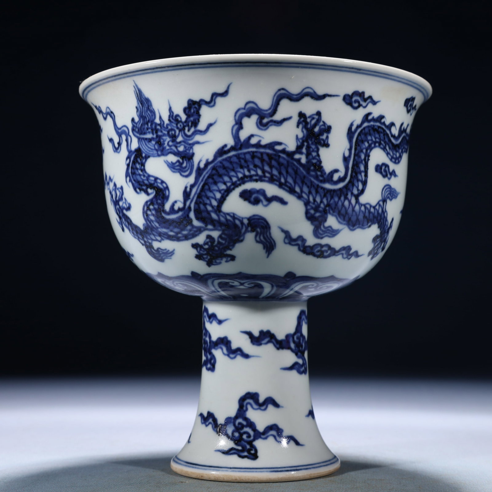 An Exquisite Blue and White Auspicious Cloud and Dragon Pattern Stem Cup: An Exquisite Blue and White Auspicious Cloud and Dragon Pattern Stem Cup,Ming Dynasty,China,Xuande Six-character Mark,Size:6.3inx6.7in,Weight:950g