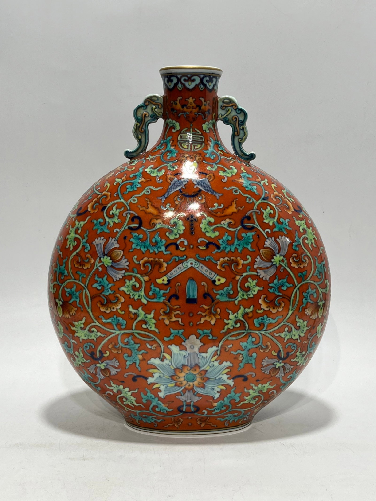 A Rare Red Ground Famille-Rose Painted Gold Lotus Pattern Double-Ears Vase: A Rare Red Ground Famille-Rose Painted Gold Lotus Pattern Double-Ears Vase,Qing Dynasty,China,Qianlong Six-character Mark,Size:13.4in