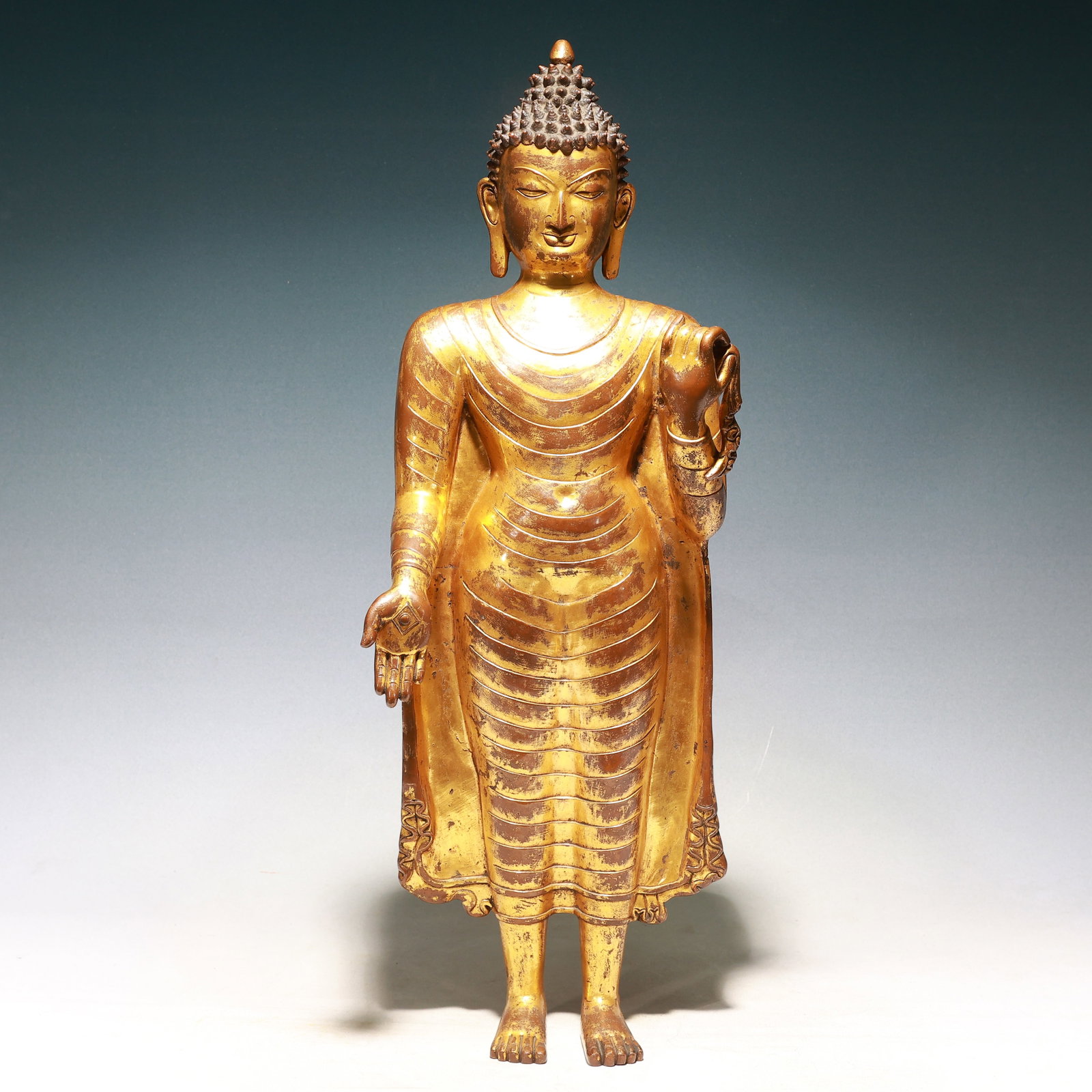 A Solemn Gilt Bronze Statue of Sakyamuni: A Solemn Gilt Bronze Statue of Sakyamuni,Qing Dynasty, China,Size:9.1inx5.5inx29.5in,Weight:13000g 铜鎏金释迦摩尼像,中国清代