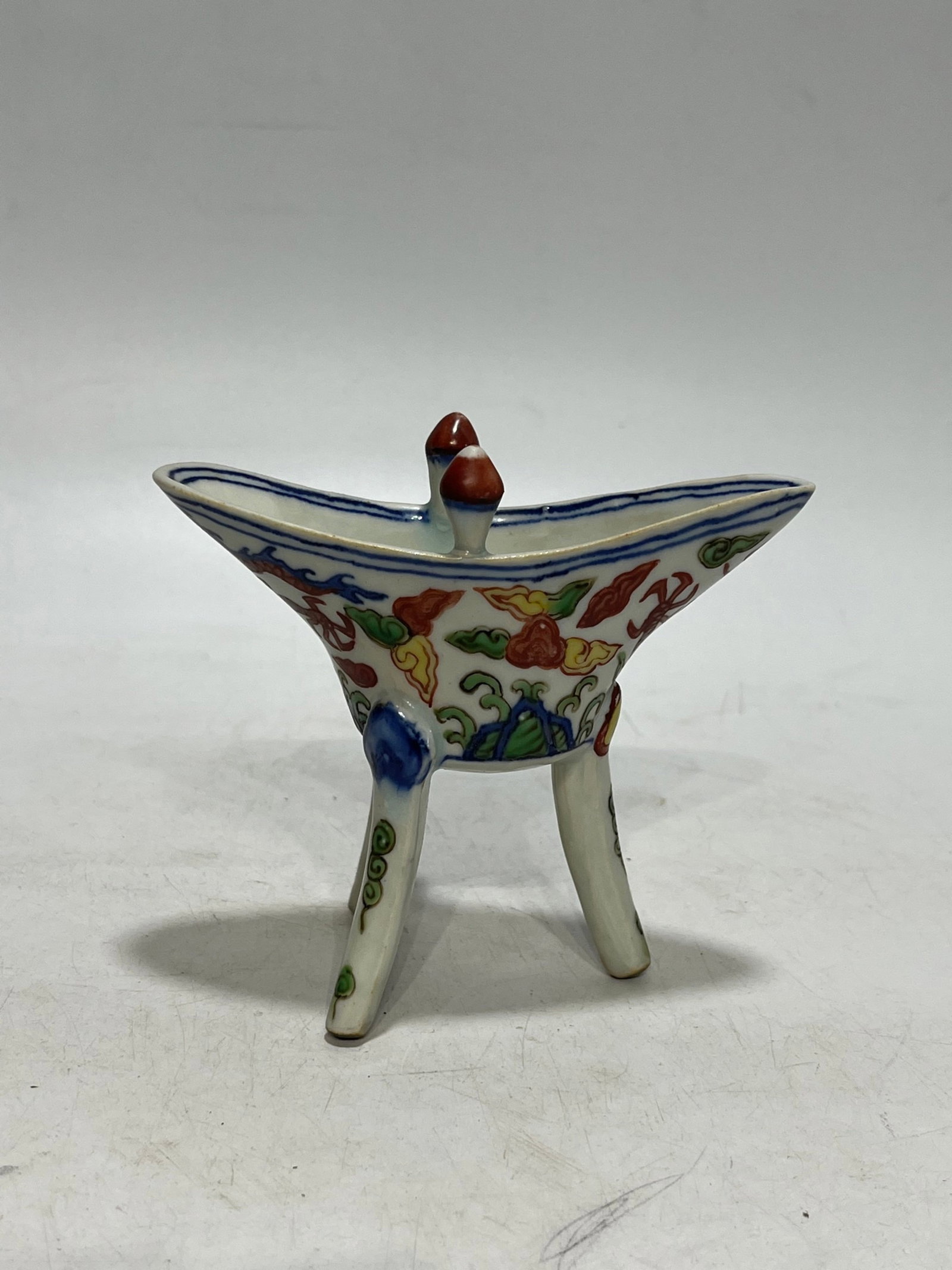 An Exquisite Wucai Auspicious Cloud and Dragon Pattern Double-Ears Tripod Cup: An Exquisite Wucai Auspicious Cloud and Dragon Pattern Double-Ears Tripod Cup,Ming Dynasty,China,Jiajing Six-character Mark,Size:4.3in 五彩祥云龙纹双耳&