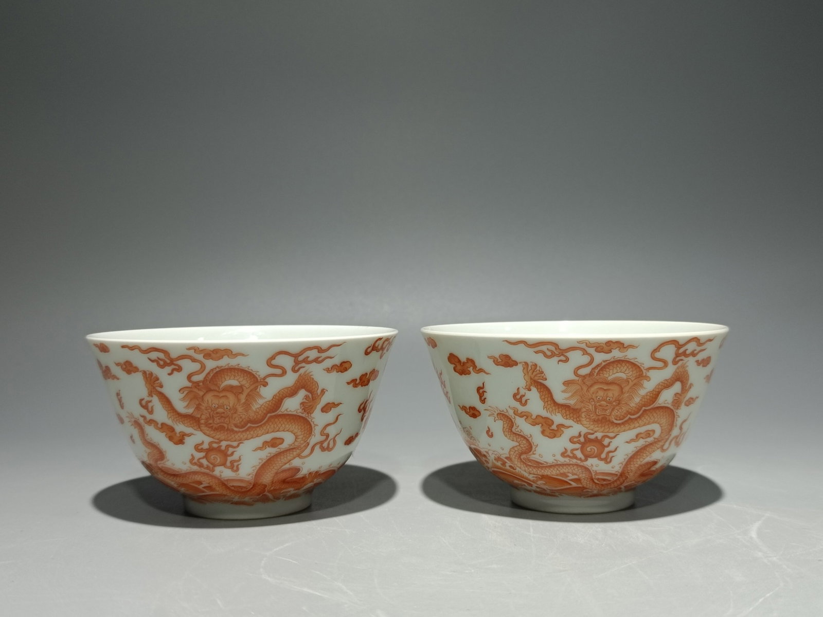 A Pair of Exquisite Iron-Red Seawater Auspicious Cloud and Dragon Pattern Cups: A Pair of Exquisite Iron-Red Seawater Auspicious Cloud and Dragon Pattern Cups,Qing Dynasty,China,Yongzheng Six-character Mark,Size:2.1inx3.6in