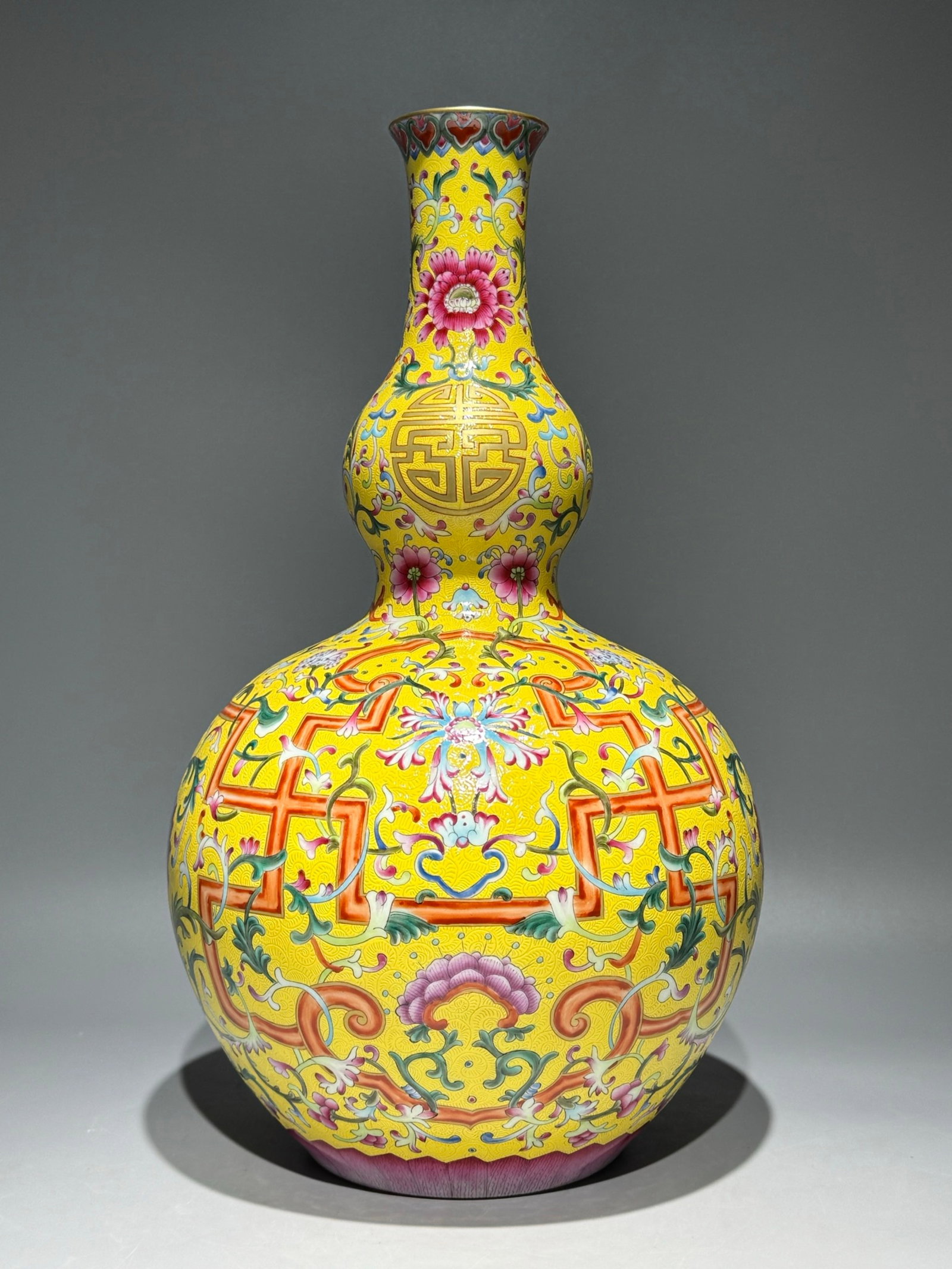 A Huge Famille-Rose Yellow Ground Painted Gold Lotus Pattern Gourd Vase: A Huge Famille-Rose Yellow Ground Painted Gold Lotus Pattern Gourd Vase,Qing Dynasty,China,Qianlong Six-character Mark,Size:15.7inx9.3in 粉彩黄地描金缠枝