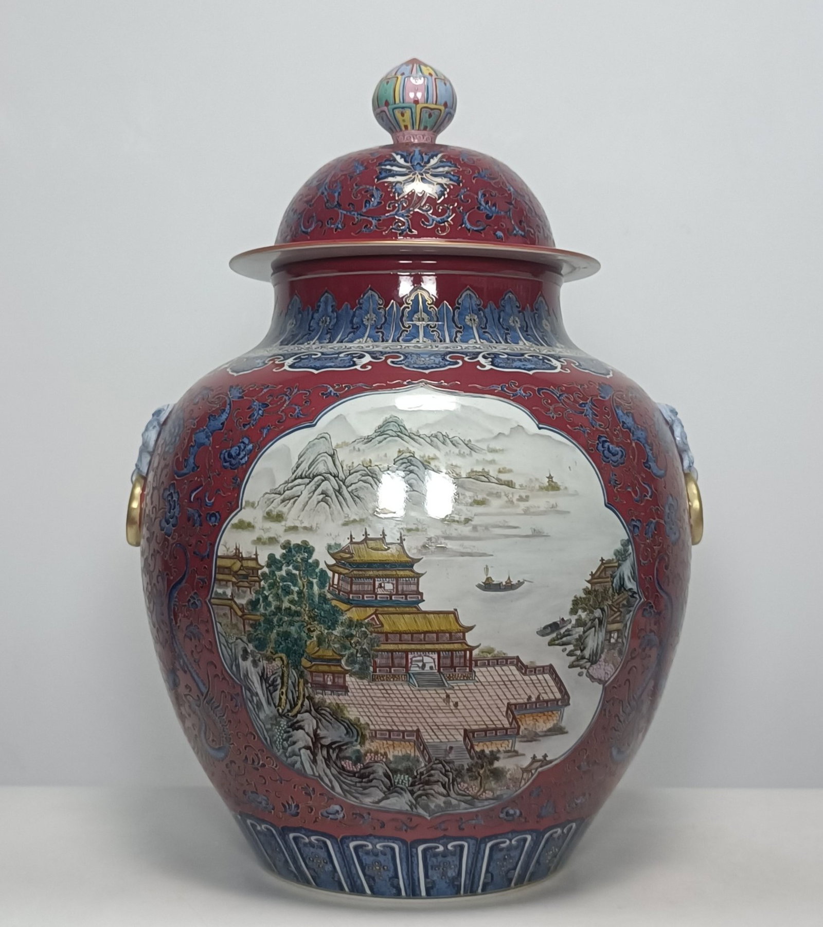 A Huge Blue and White Famille-Rose Ruby Red Ground Landscape??Lotus and Dragon Pattern Beast-Ears: A Huge Blue and White Famille-Rose Ruby Red Ground Landscape,Lotus and Dragon Pattern Beast-Ears Cover Jar,Qing Dynasty,China,Qianlong Six-character Mark,Size:26.4inx18.9in 青花粉