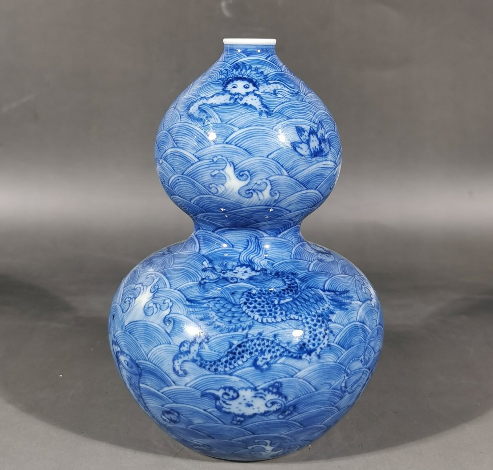 An Exquisite Blue and White Seawater and Auspicious Beast Pattern Gourd-Shaped Vase: An Exquisite Blue and White Seawater and Auspicious Beast Pattern Gourd-Shaped Vase,Qing Dynasty, China,Qianlong Six-character Mark,Size:5.7inx3.7in 青花海水瑞兽