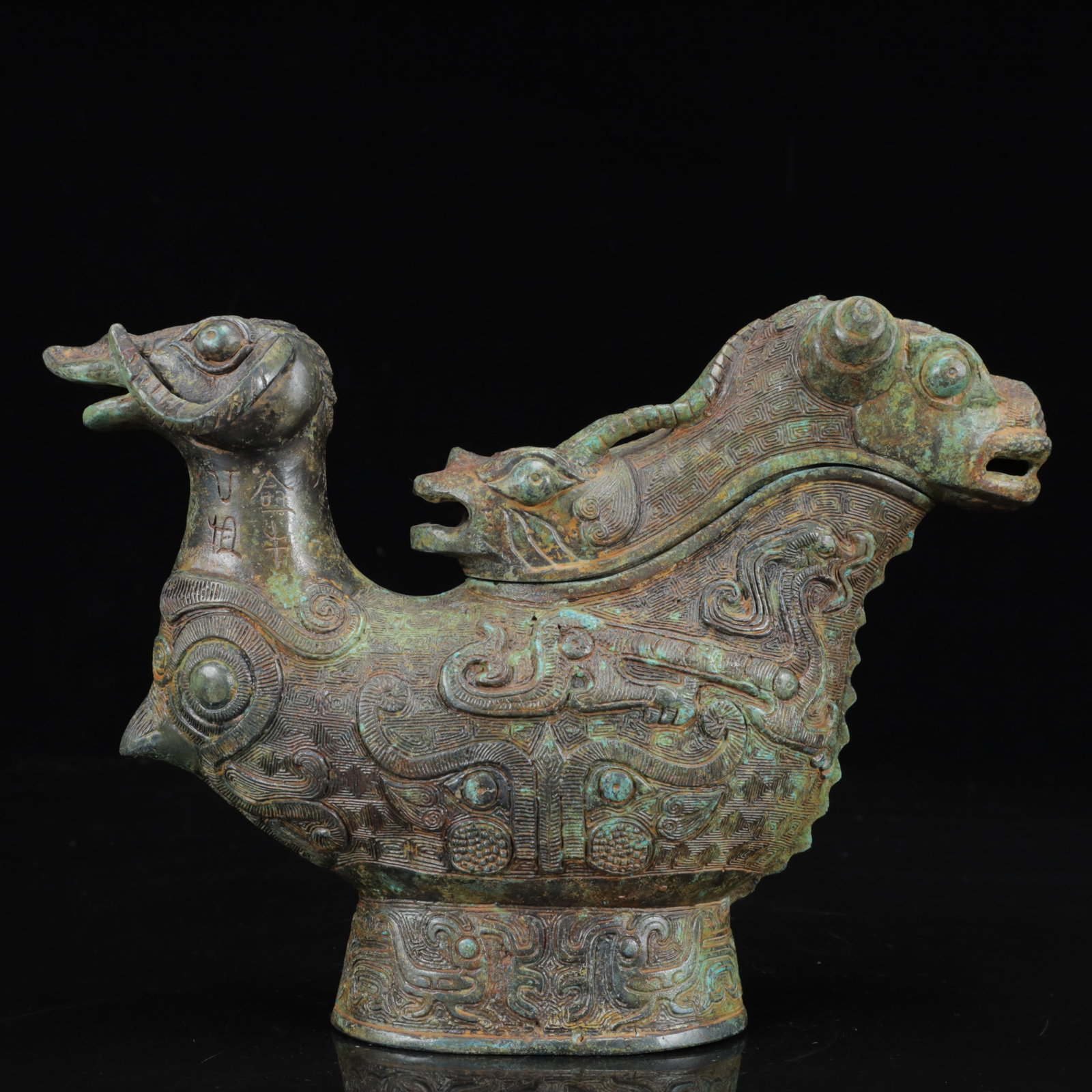 An Archaic Bronze Beast-Face Pattern Sheep Cup,with Inscription: An Archaic Bronze Beast-Face Pattern Sheep Cup,with Inscription,the Warring States Period in China,Size:9.8inx2.8inx7.1in,Weight:1900g 青铜兽面纹羊杯,带