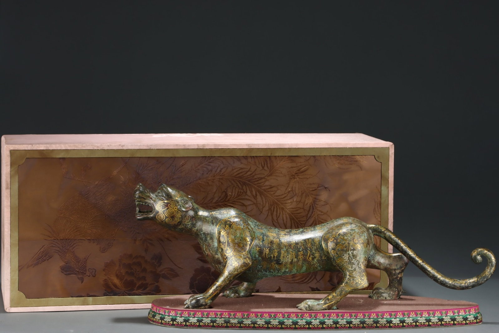 An Archaic Bronze Inlaid Gold Tiger Ornament,With Inscription: An Archaic Bronze Inlaid Gold Tiger Ornament,With Inscription,the Warring States period in China,Size:9.4inx27.6in 青铜错金虎摆件,带铭文,