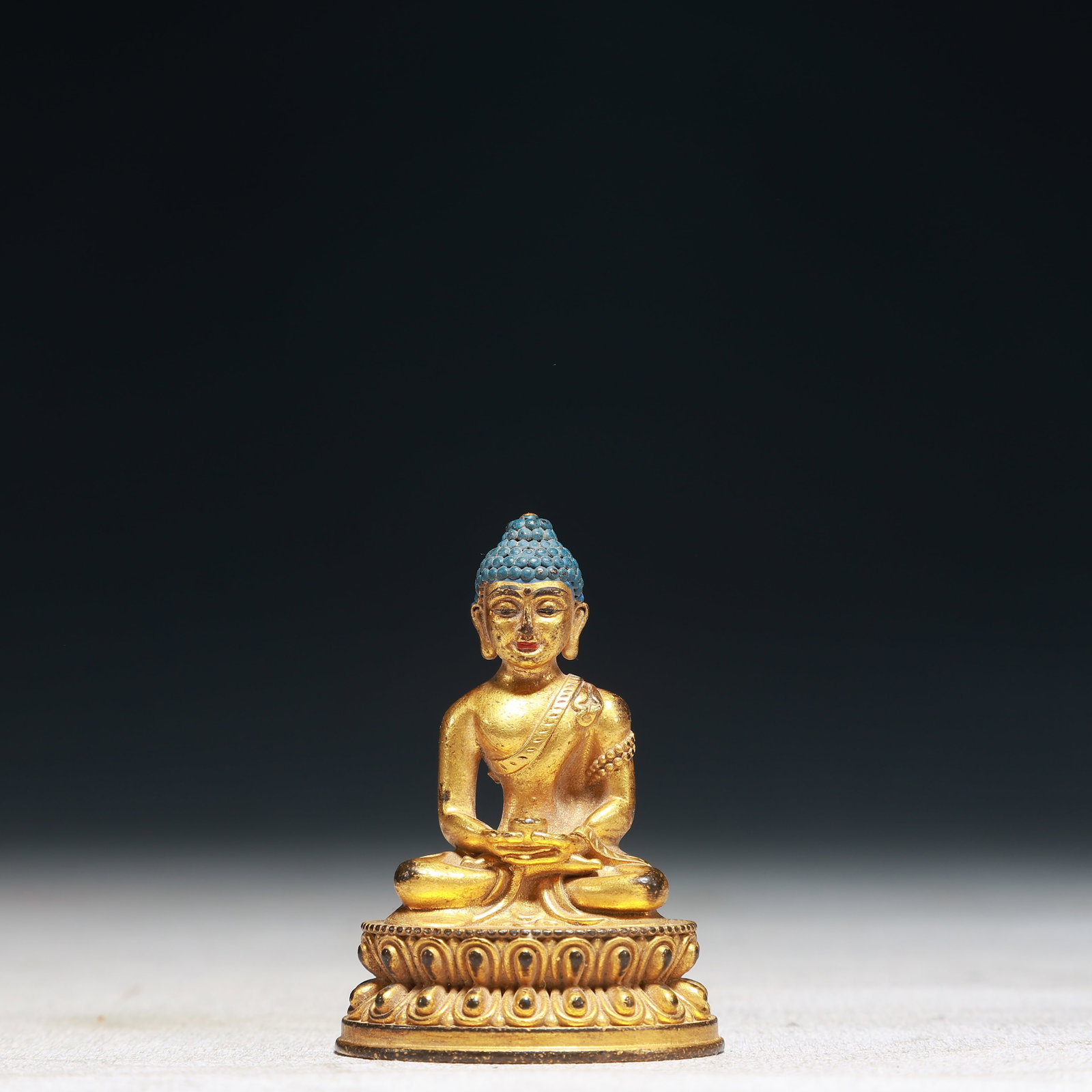 A Solemn Gilt Bronze Statue of Sakyamuni: A Solemn Gilt Bronze Statue of Sakyamuni,Qing Dynasty,China,Size:1.6inx1.2inx2.2in,Weight:50g 铜鎏金释迦摩尼像,中国清代