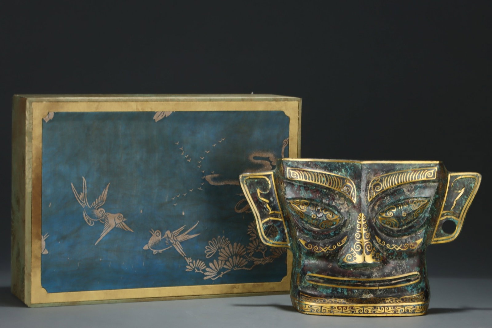 An Archaic Bronze Inlaid Gold Beast-Face Pattern Mask,With Inscription: An Archaic Bronze Inlaid Gold Beast-Face Pattern Mask,With Inscription,the Warring States period in China,Size:9.4inx15.4in 青铜错金兽面纹面具,