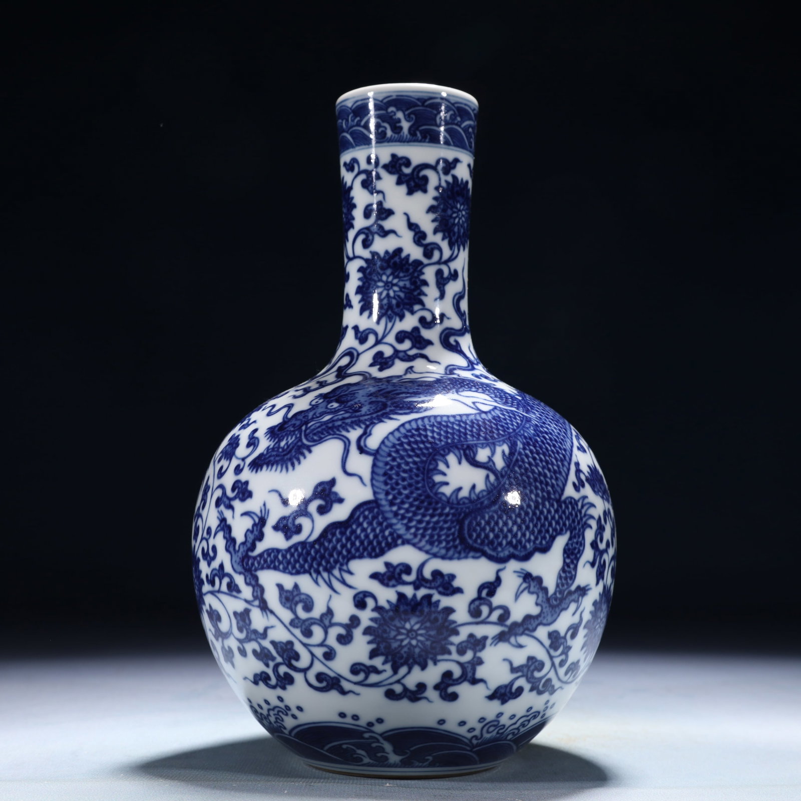An Exquisite Blue and White Lotus and Dragon Pattern Vase: An Exquisite Blue and White Lotus and Dragon Pattern Vase,Qing Dynasty,China,Qianlong Six-character Mark,Size:5.1inx9.1in,Weight:1450g 青花缠枝莲龙纹瓶,