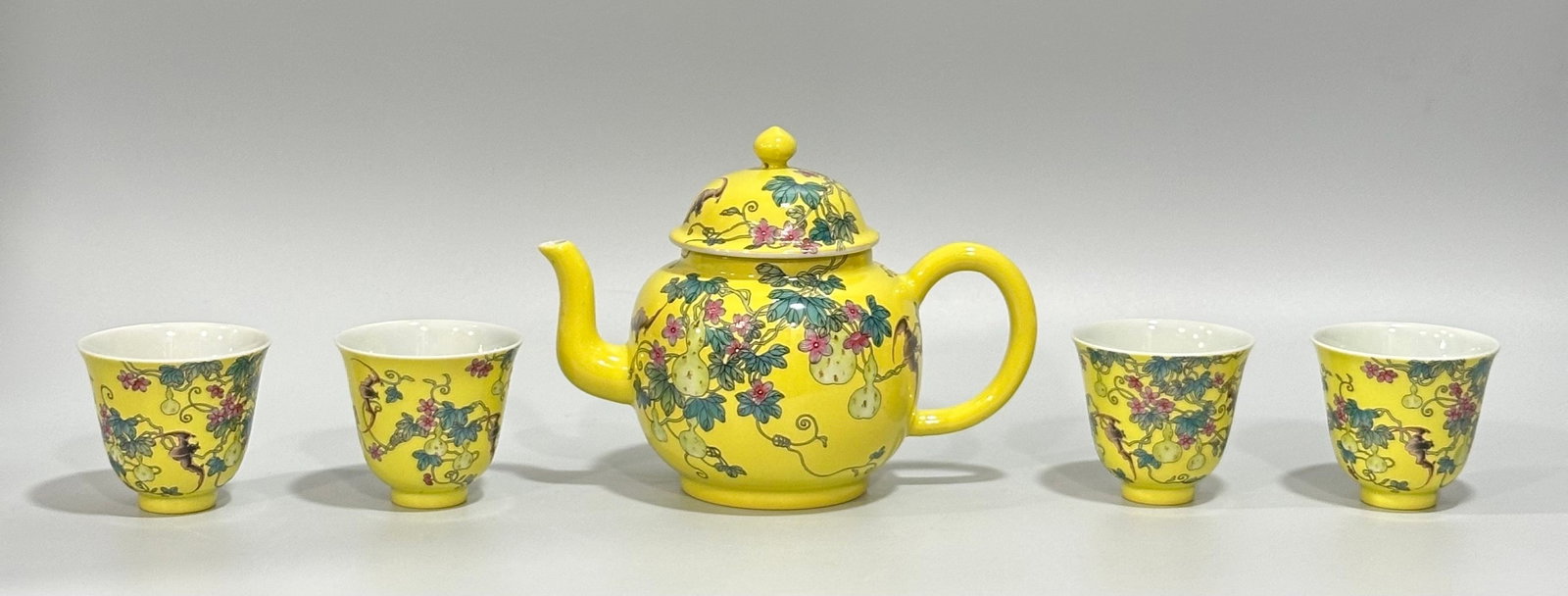 A Set of Fine Yellow Glazed Enamel Bats and Groud Pattern Teapot,with Four Cups: A Set of Fine Yellow Glazed Enamel Bats and Groud Pattern Teapot,with Four Cups,Qing Dynasty,China,Yongzheng Four-character Mark,Size:(Pot)5.5inx4.3in,(Cup)2.4inx2.6in
