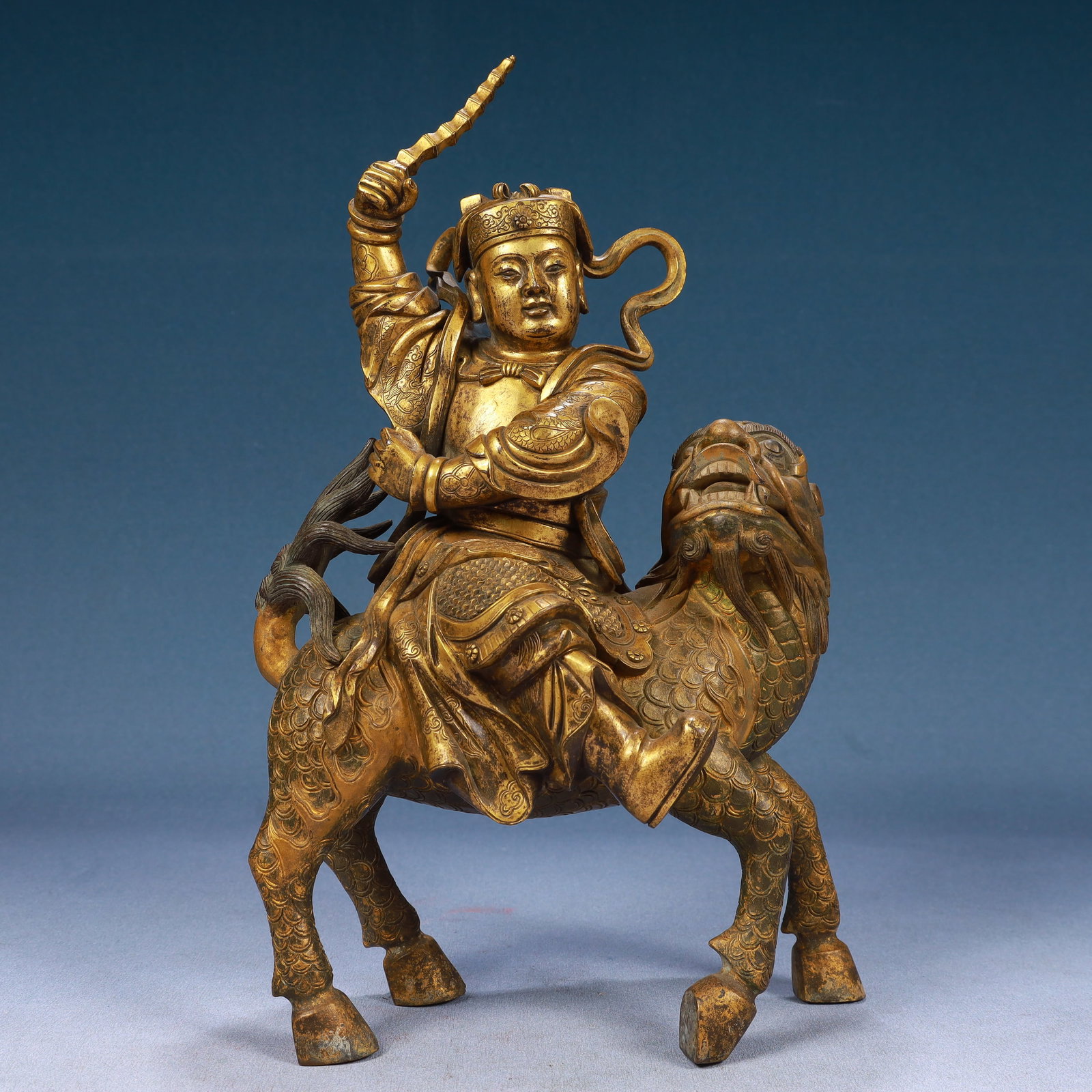 A Solemn Gilt Bronze Statue of Dharma Protector Rides the Kylin: A Solemn Gilt Bronze Statue of Dharma Protector Rides the Kylin,Qing Dynasty, China,Size:7.5inx5.1inx12.6in,Weight:6050g 铜鎏金骑麒麟护法像,ߑ