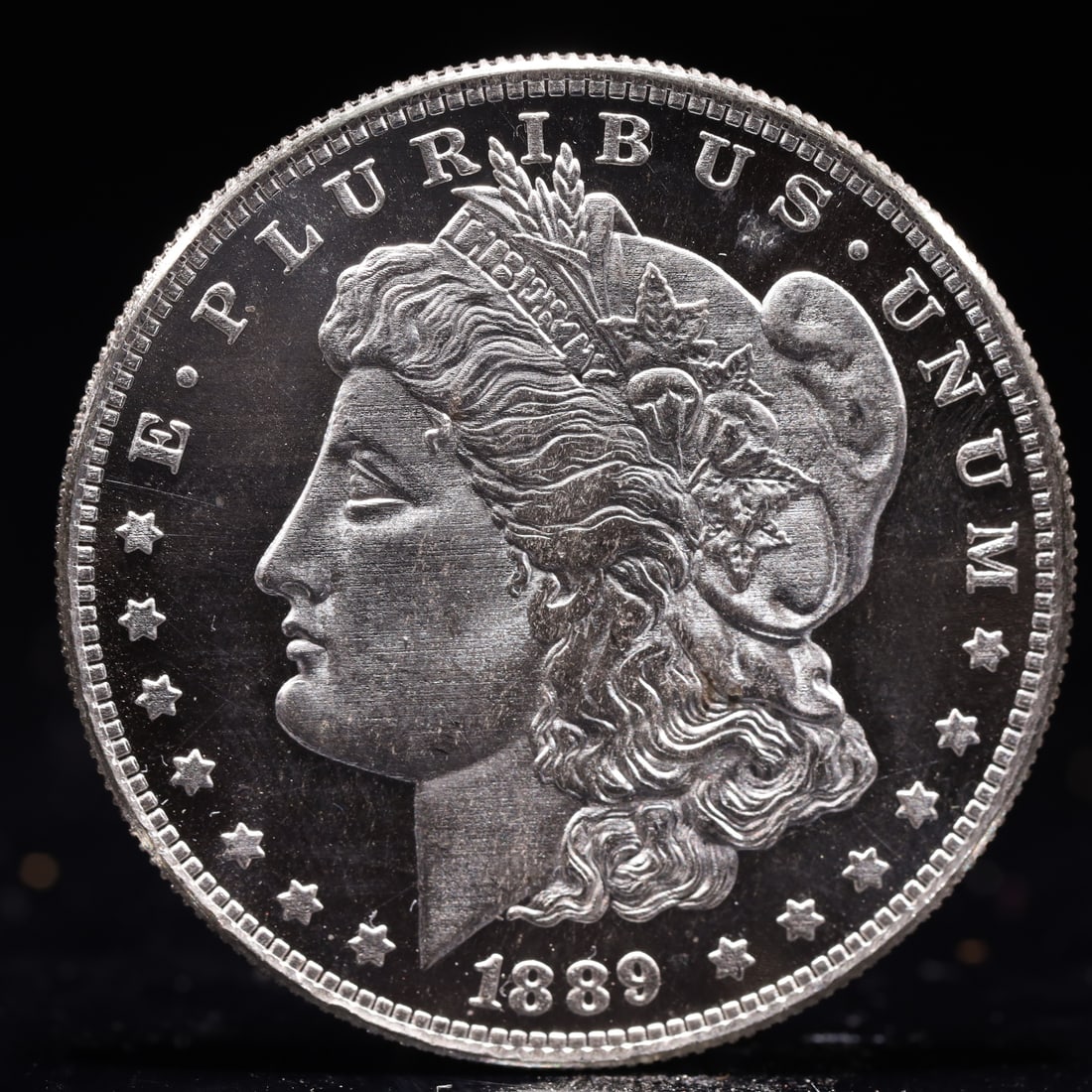 USA Morgan Dollar 1889 Coin: Obv: profile bust with date below and E PLURIBUS UNUM legend and stars around. Rev: eagle with In God we trust above within wreath with UNITED STATES OF AMERICA ONE DOLLAR legend. IN GOD WE TRUST / LI