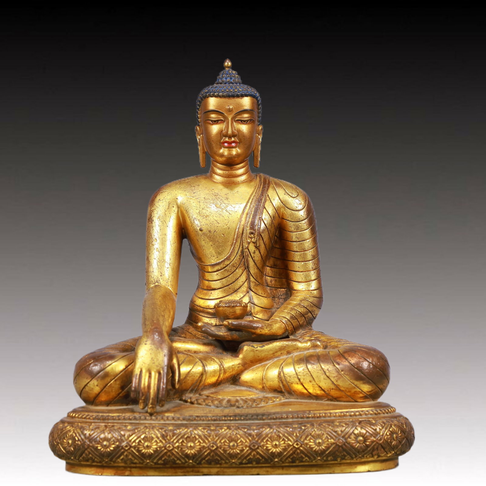 A Solemn Gilt Bronze Statue of Sakyamuni: A Solemn Gilt Bronze Statue of Sakyamuni, Qing Dynasty, China, Qianlong Mark, Size:7.9inx4.7inx9.1in, Weight:2550g 铜鎏金释迦摩尼像,中国