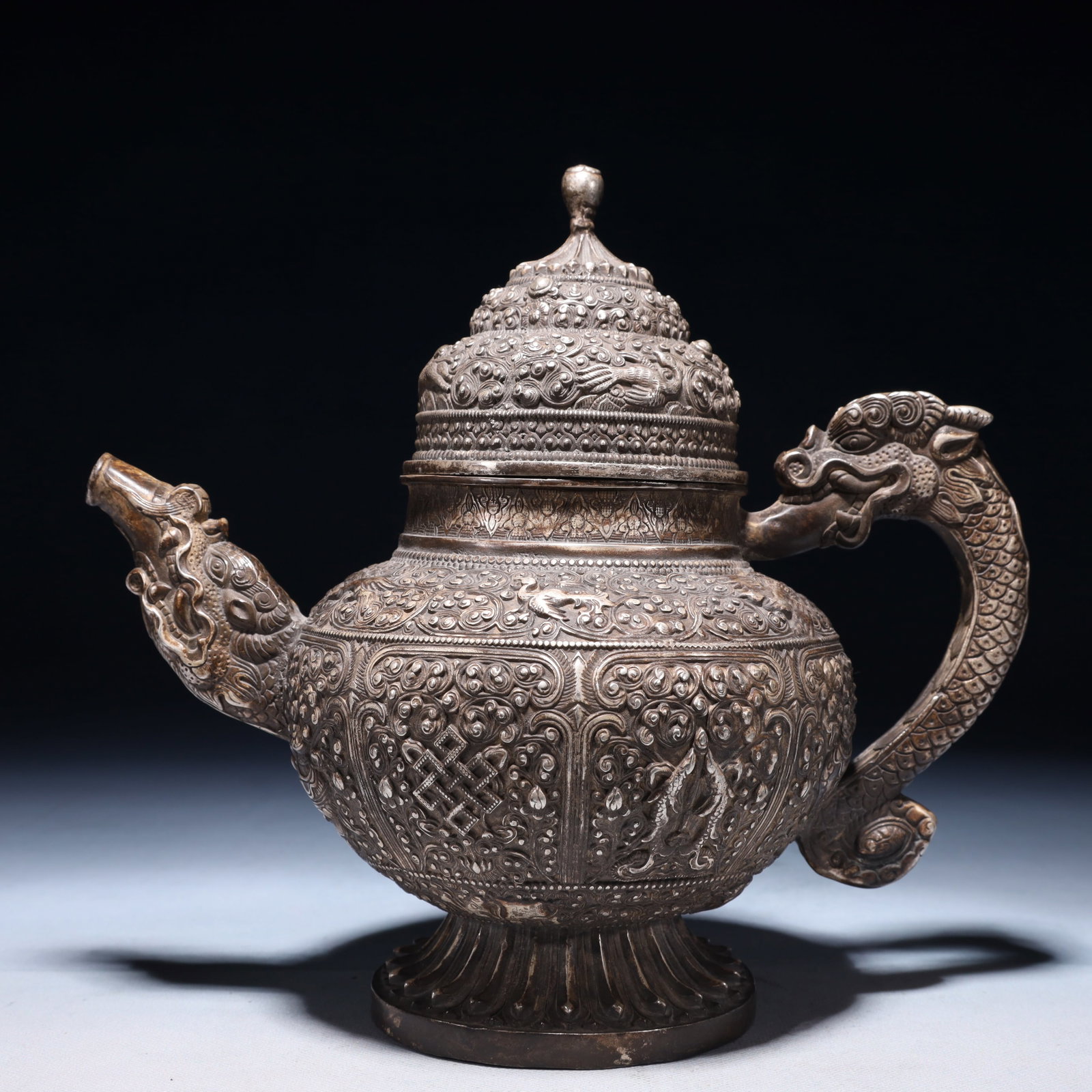 An Exquisite Silver-plated Bronze Eight Treasures Pattern Teapot: An Exquisite Silver-plated Bronze Eight Treasures Pattern Teapot,Qing Dynasty,China,Size:9.8inx5.5inx9.1in,Weight:2150g 铜镀银八宝纹茶壶,中国
