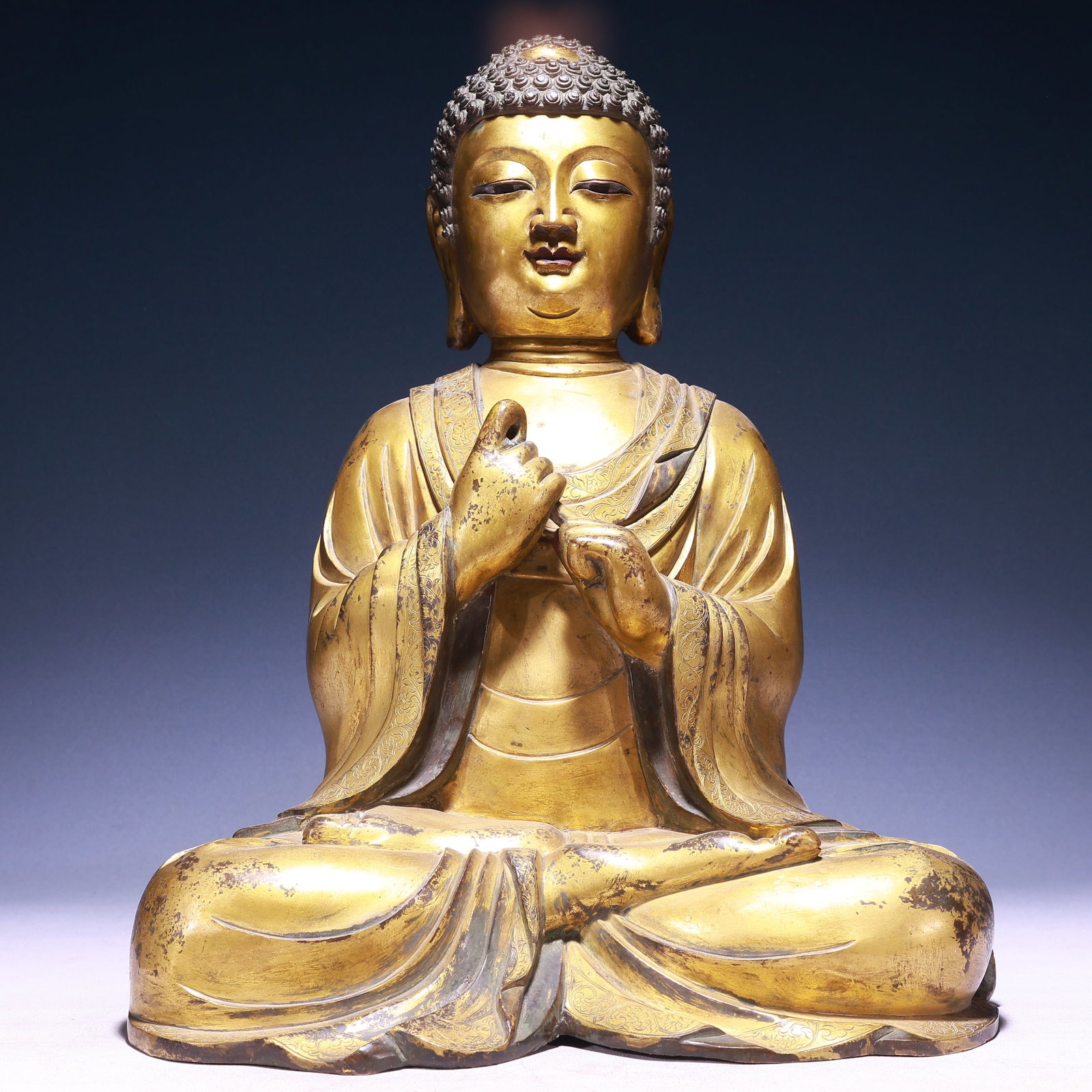 A Solemn Gilt Bronze Statue of Sakyamuni: A Solemn Gilt Bronze Statue of Sakyamuni,Ming Dynasty,China,Wanli Mark,Size:14.2inx9.8inx19.3in,Weight:20500g 铜鎏金如来像,中国明代,万