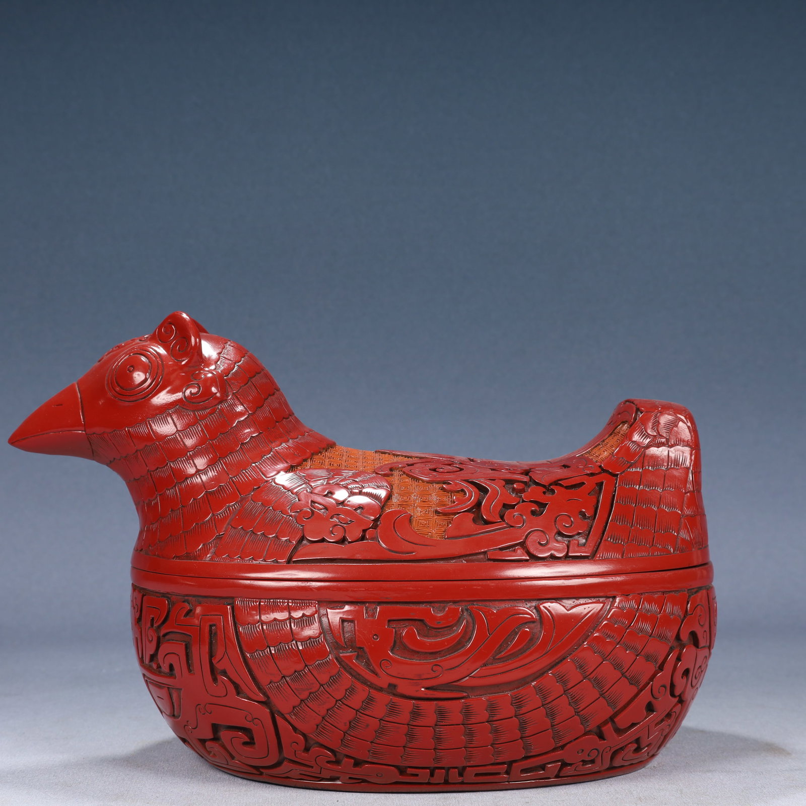 A Rare Carved Red Lacquer Beast-Face Pattern Bird-Shaped Cover Box: A Rare Carved Red Lacquer Beast-Face Pattern Bird-Shaped Cover Box,Qing Dynasty, China,Qianlong Six-character Mark,Size:11.8inx7.1inx8.3in,Weight:1600g 剔红漆兽面纹
