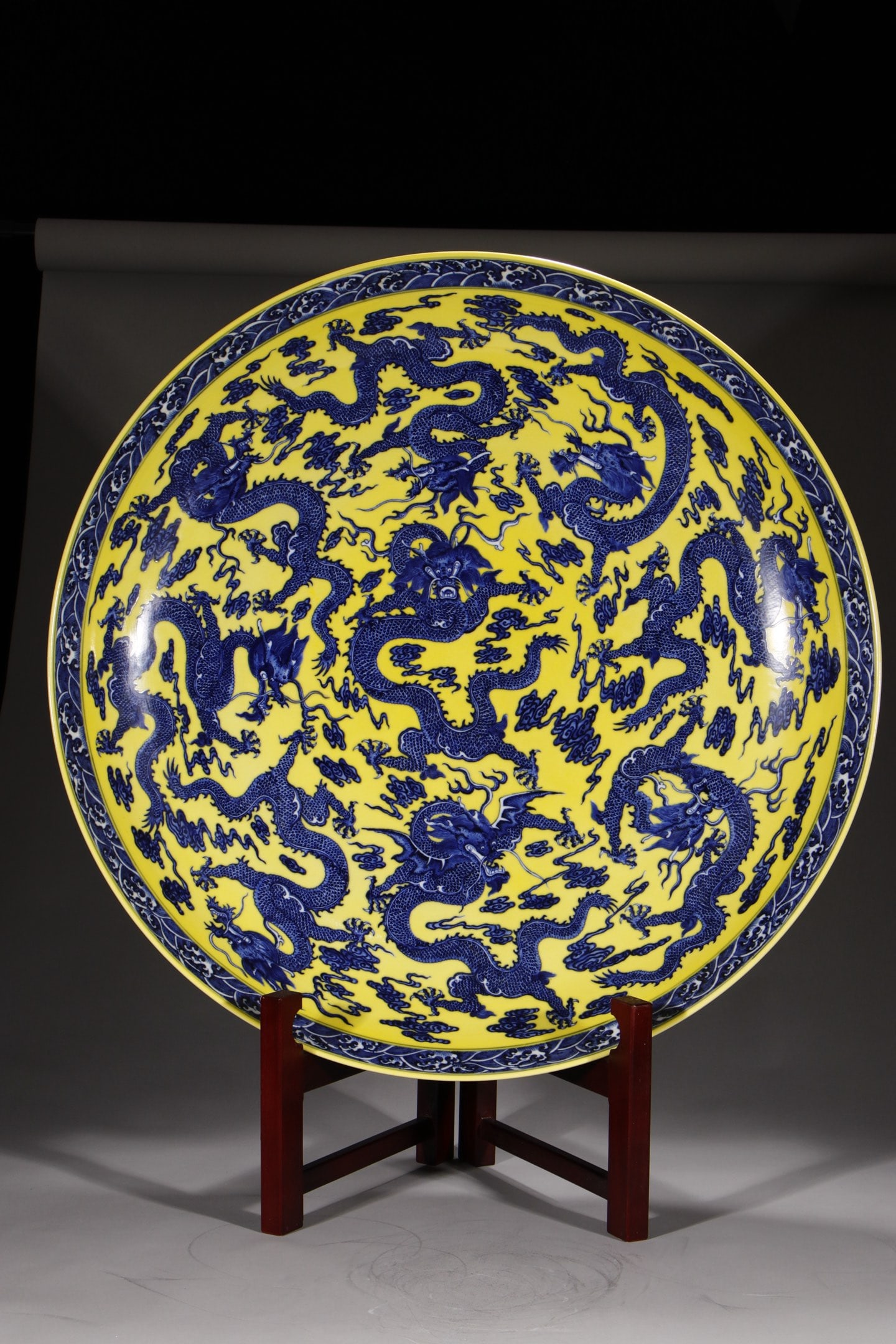 A Huge Yellow Ground Blue and White Seawater Auspicious Cloud and Dragon Pattern Plate: A Huge Yellow Ground Blue and White Seawater Auspicious Cloud and Dragon Pattern Plate,Qing Dynasty,China,Qianlong Six-character Mark,Size:4.9inx28.3in 黄地青花海水