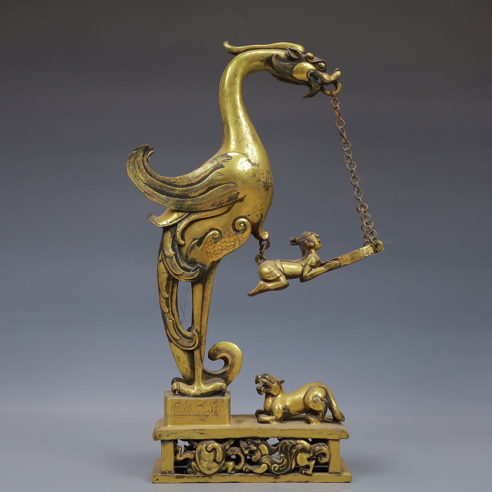 A Huge Auspicious Beast Candlestick,With Inscription: A Huge Auspicious Beast Candlestick,With Inscription,Qing Dynasty, China,Size:9.4inx2.8inx15.7in,Weight:3750g 铜鎏金瑞兽烛台,带铭文,中