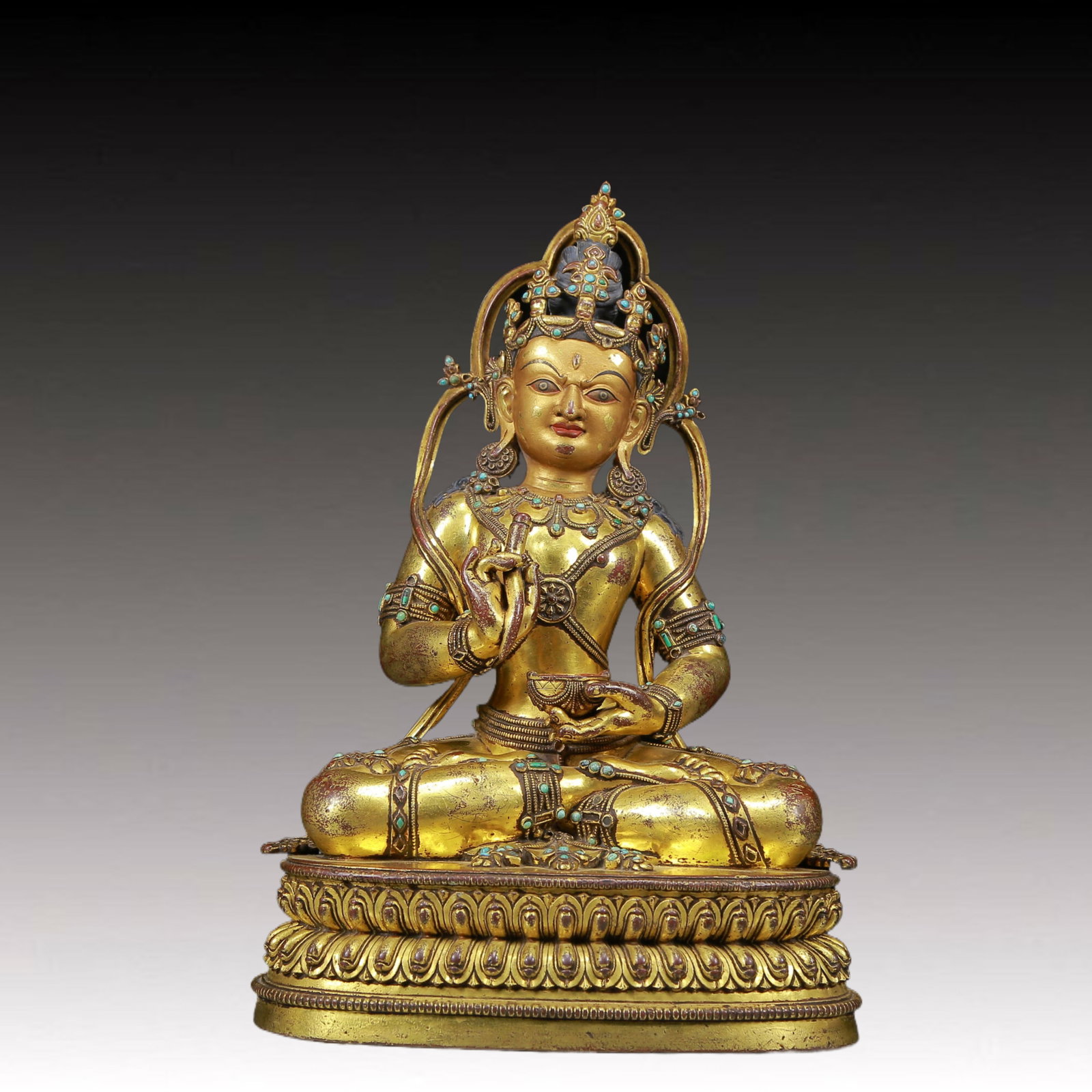 solemn gilt bronze statue of Bodhisattva inlaid with turquoise: A solemn gilt-bronze inlaid turquoise Bodhisattva statue Ming Dynasty, China. The Bodhisattva has a graceful and peaceful posture. His face is solemn and kind, and his eyes are deep, as if he can see 