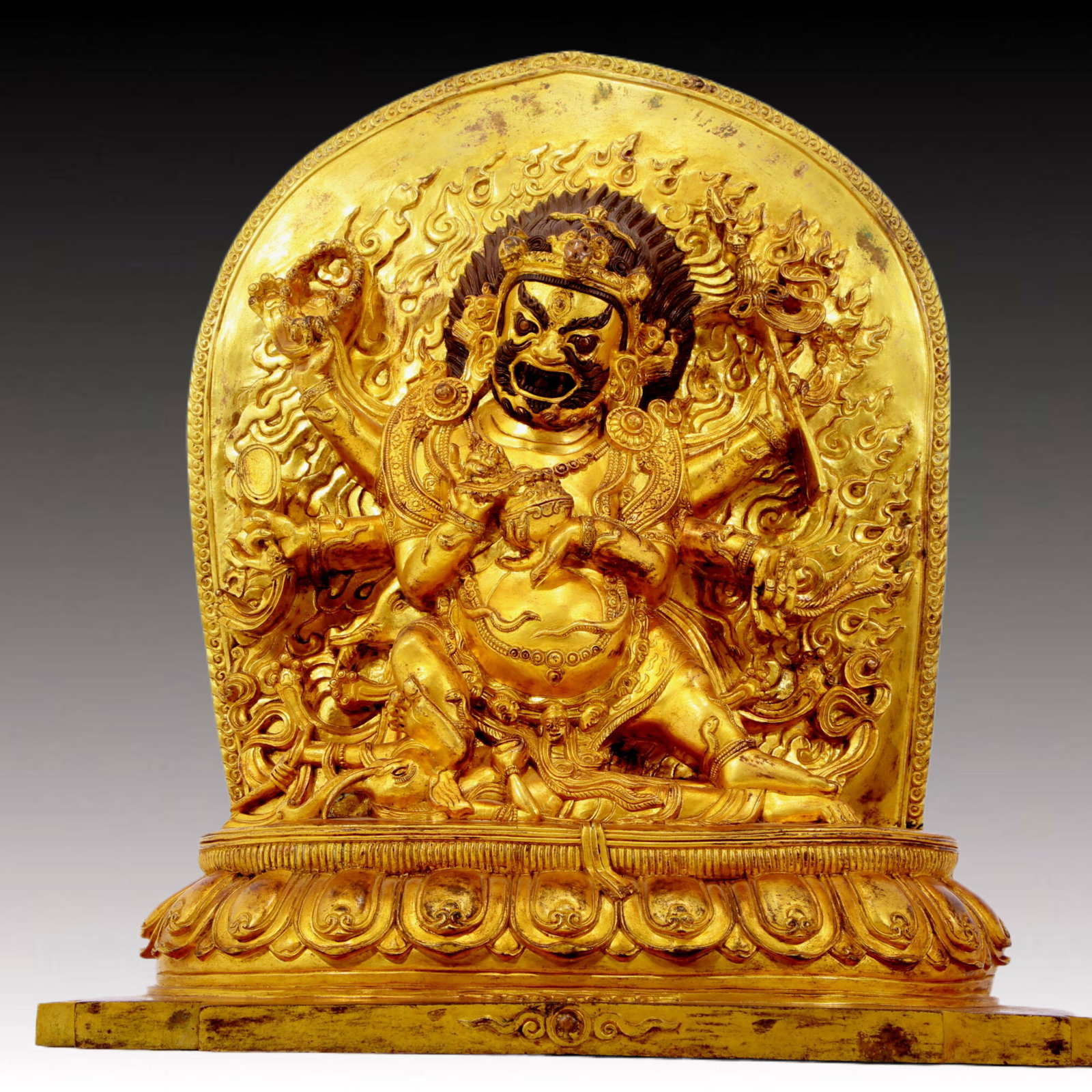 A solemn gilt bronze Vajra statue: A solemn gilt-bronze Vajra statue from the Qing Dynasty in China. The Vajra's figure is solemn and majestic, symbolizing strong will and invincible power. At the same time, his face is solemn, and his