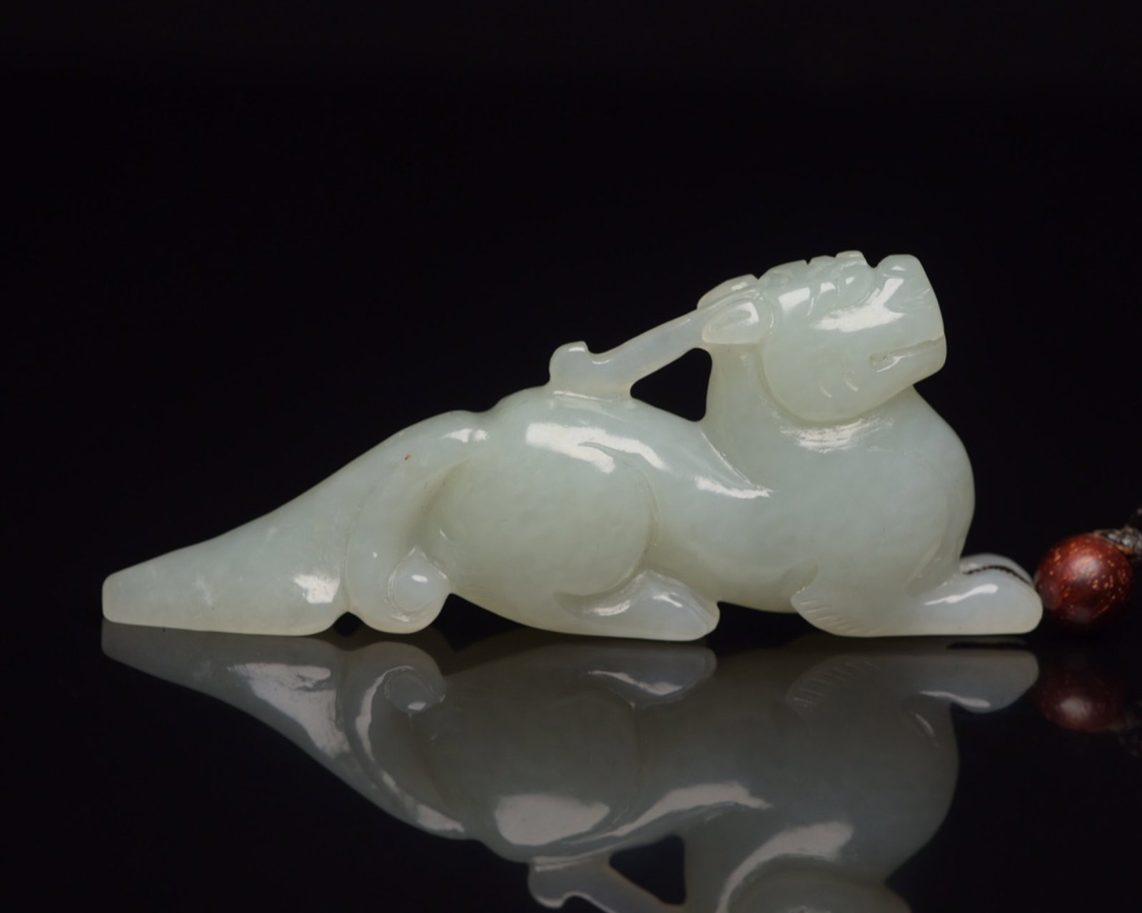 An Exquisite White Jade Auspicious Beast Ornament: An Exquisite White Jade Auspicious Beast Ornament,Qing Dynasty,China,Size:3inx1.2inx0.5in,Weight:36g 白玉瑞兽摆件,中国清代
