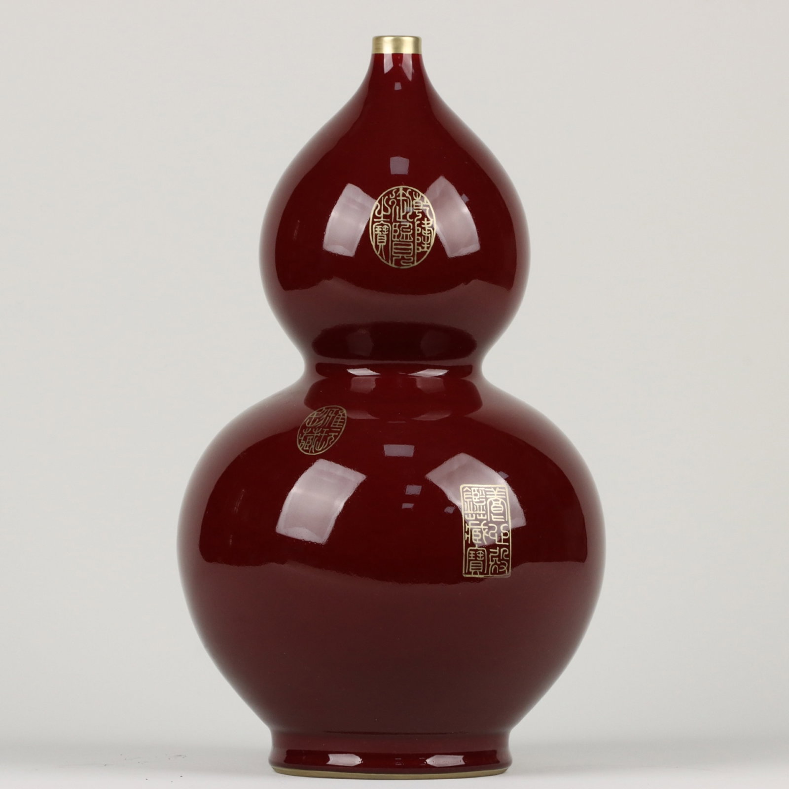 A Rare Red Glazed Gilt Gourd-Shaped Vase: A Rare Red Glazed Gilt Gourd-Shaped Vase,Qing Dynasty,China,Qianlong Six-character Mark,Size:13inx7.1in 红釉鎏金葫芦瓶,中国清代,ߙ