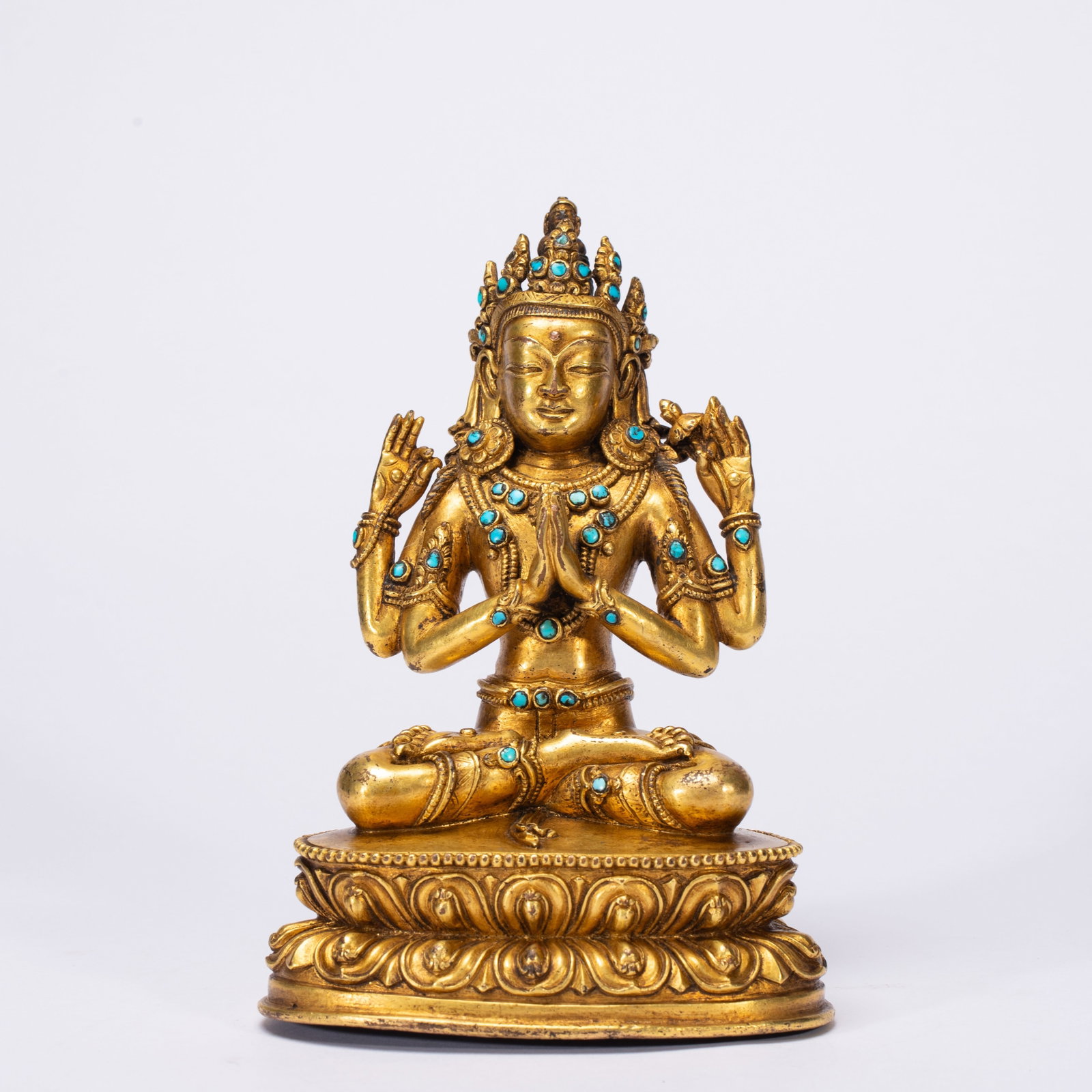A Solemn Gilt Bronze Statue of Four-Arms Avalokitesvara,Inlaid Turquoise: A Solemn Gilt Bronze Statue of Four-Arms Avalokitesvara,Inlaid Turquoise,Qing Dynasty,China,Size:4.3inx3inx5.9in,Weight:880g 铜鎏金四臂观音像,嵌&#