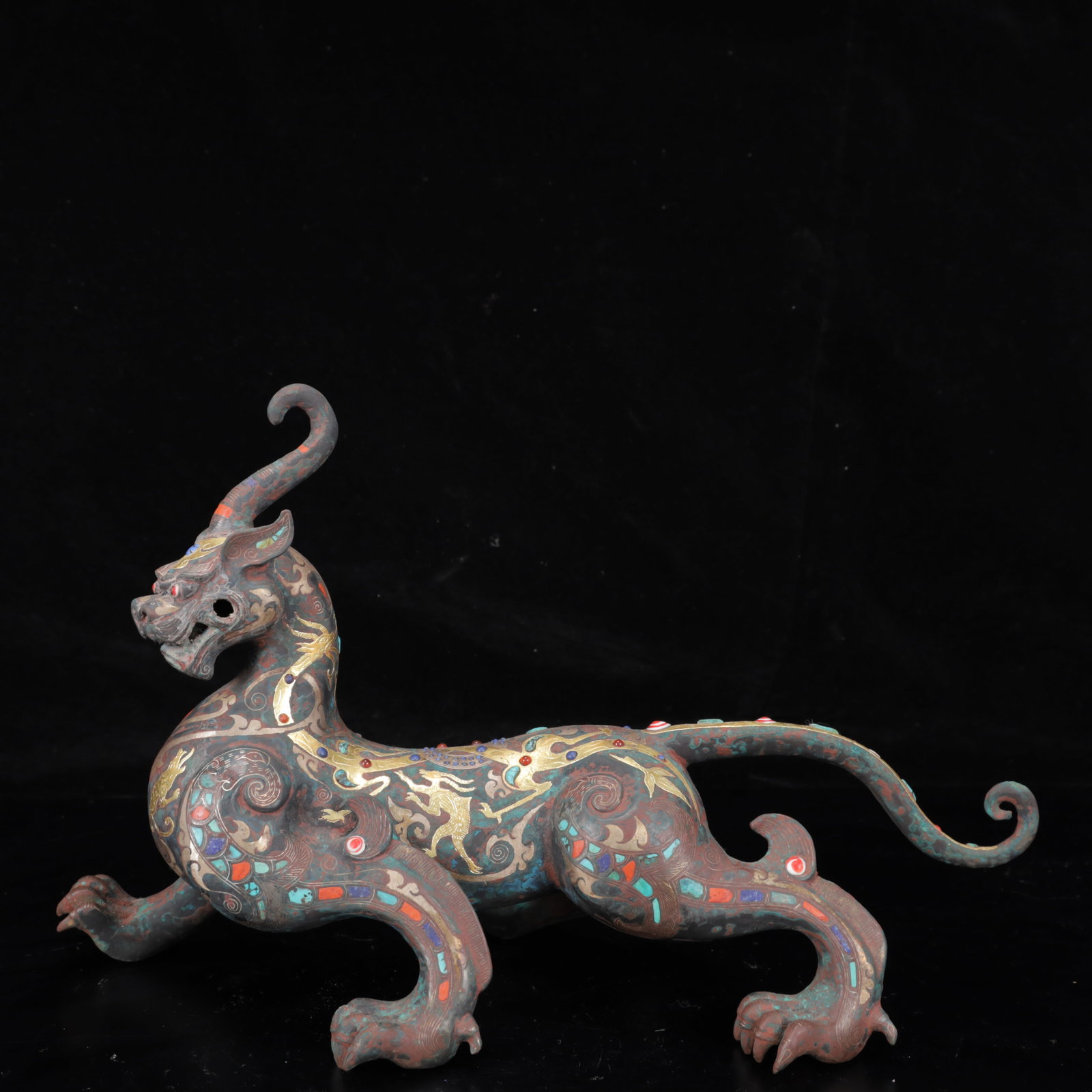 An Archaic Bronze Inlaid Gold and Silver Unicorn Ornament,Inlaid Turquoise: An Archaic Bronze Inlaid Gold and Silver Unicorn Ornament,Inlaid Turquoise,The Warring States period in China,With Mark,Size:15.4inx6.7inx9.4in,Weight:2200g 铜错金银独