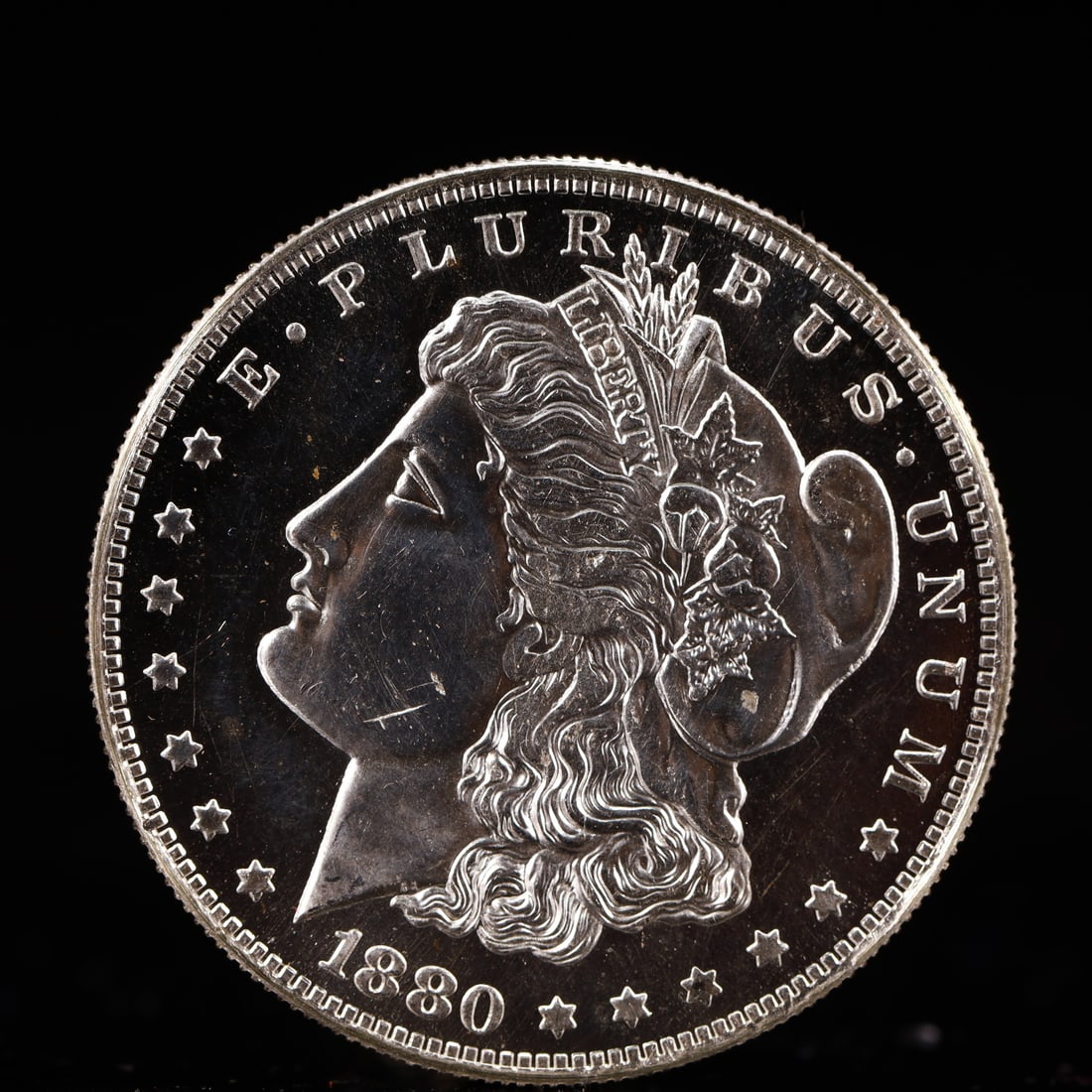 USA Morgan Dollar 1880 Coin: Obv: profile bust with date below and E PLURIBUS UNUM legend and stars around. Rev: eagle with In God we trust above within wreath with UNITED STATES OF AMERICA ONE DOLLAR legend. IN GOD WE TRUST / LI