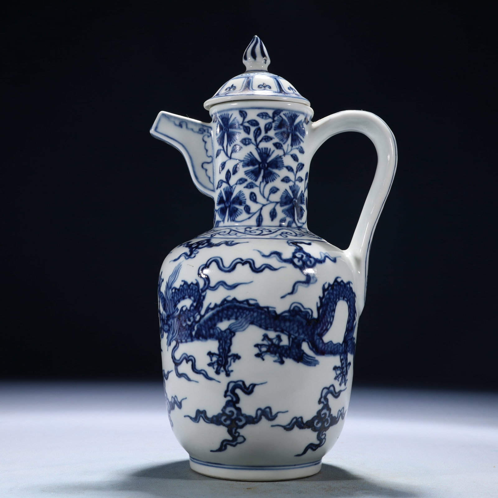 An Exquisite Blue and White Auspicious Cloud and Dragon Pattern Ewer: An Exquisite Blue and White Auspicious Cloud and Dragon Pattern Ewer,Ming Dynasty,China,Xuande Six-character Mark,Size:6.3inx4.7inx10.6in,Weight:1550g 青花祥云龙纹&
