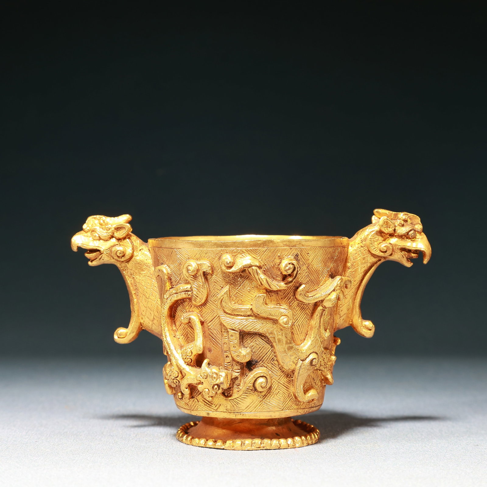 An Exquisite Gilt Bronze Dragon and Phoenix Pattern Phoenix-Ears Cup: An Exquisite Gilt Bronze Dragon and Phoenix Pattern Phoenix-Ears Cup,Qing Dynasty,China,Size:5.1inx2.6inx3.1in,Weight:400g 铜鎏金龙凤纹凤耳杯,